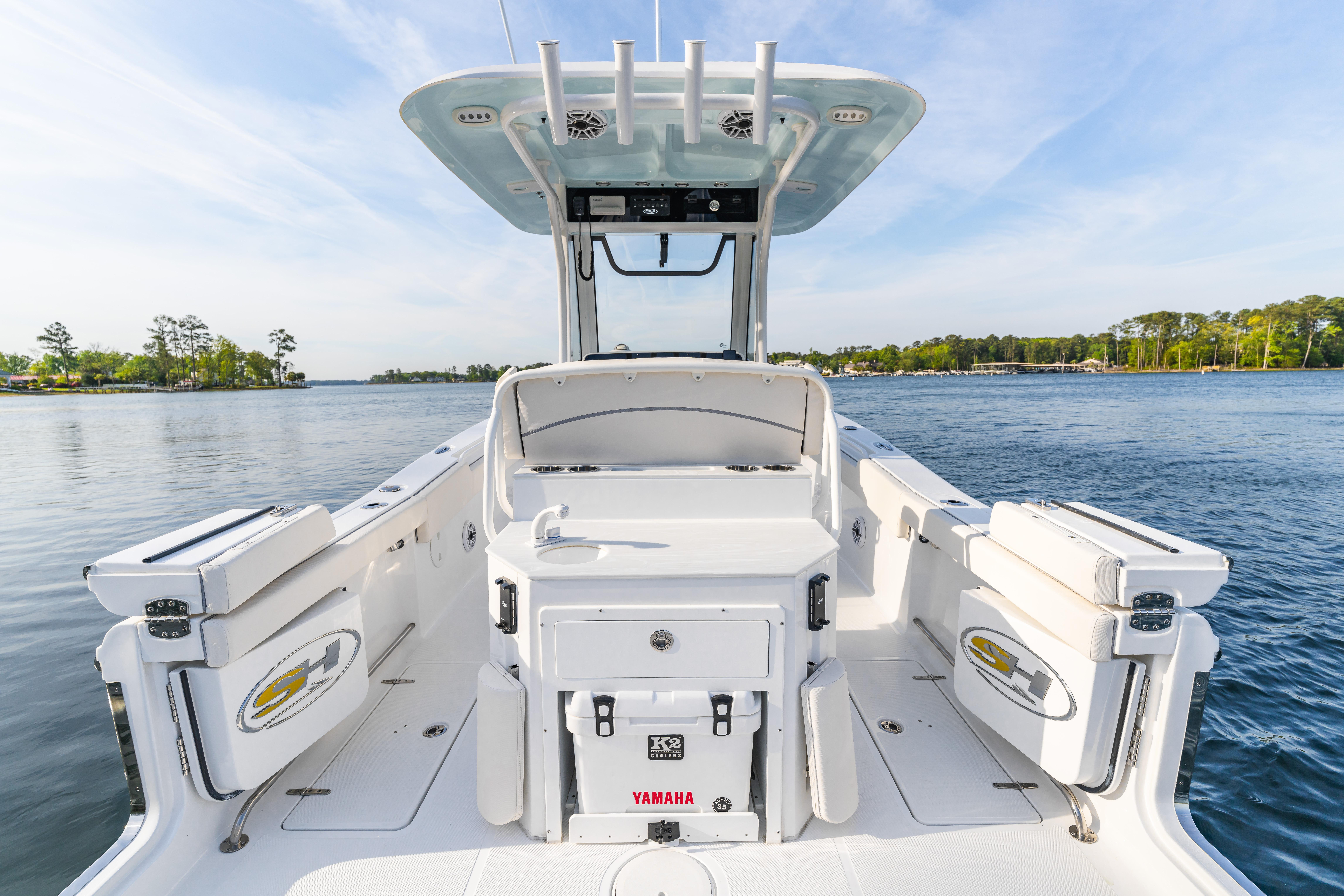 2027 Sea Hunt Ultra 275 SE boat on calm water, showcasing spacious deck and seating.
