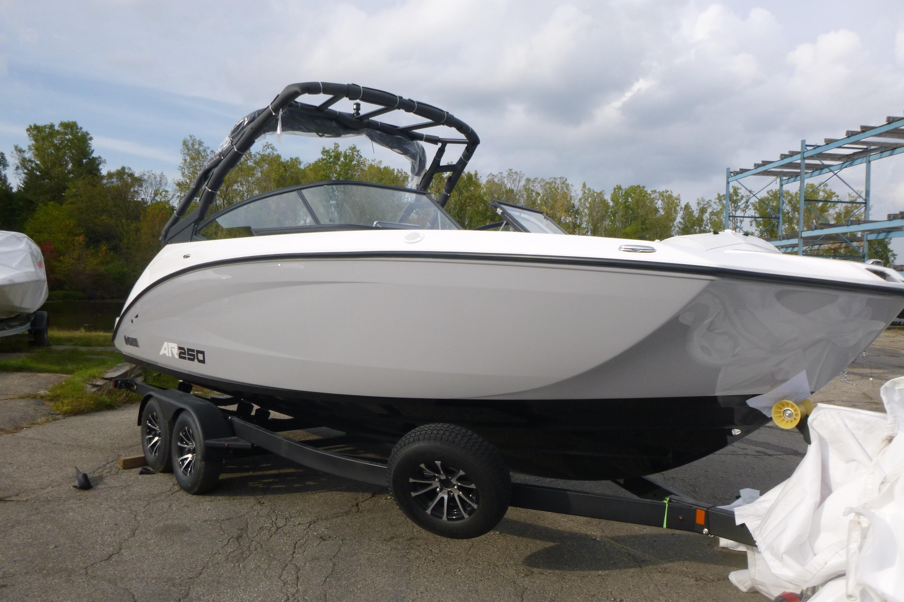 2026 Yamaha Boats AR250 on trailer, parked outdoors, under cloudy sky.