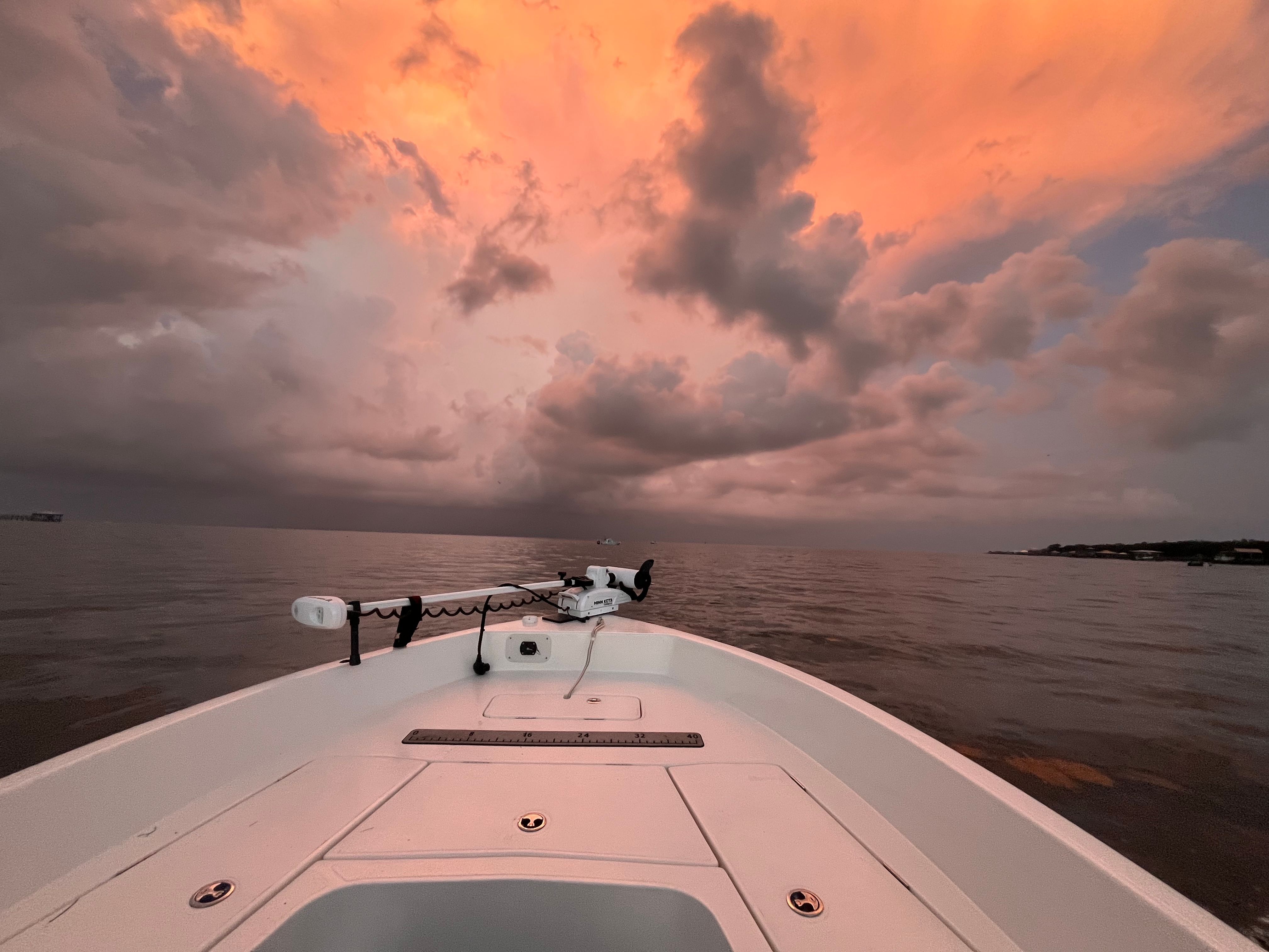 Skeeter SX2350 boat on calm water at sunset with a dramatic sky.