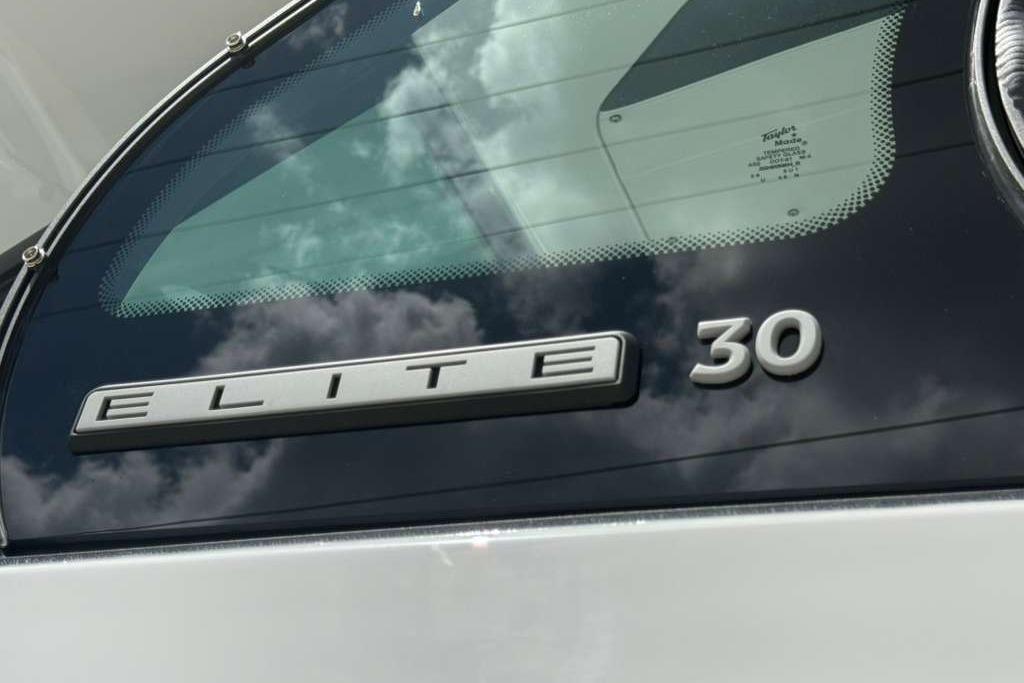 2026 Monterey Elite 30 OB boat emblem with reflective glass background.