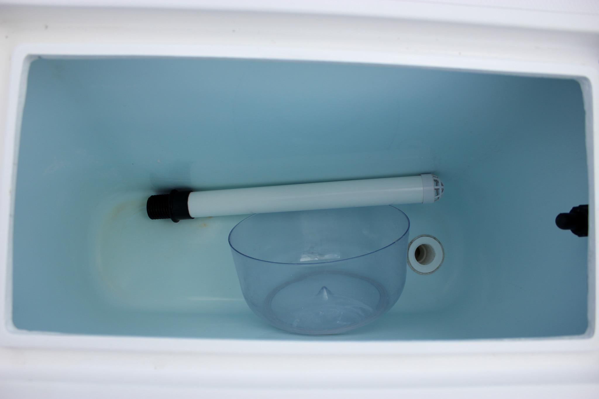 Interior of 2022 NorthCoast 235 Cabin storage compartment with light and bowl.