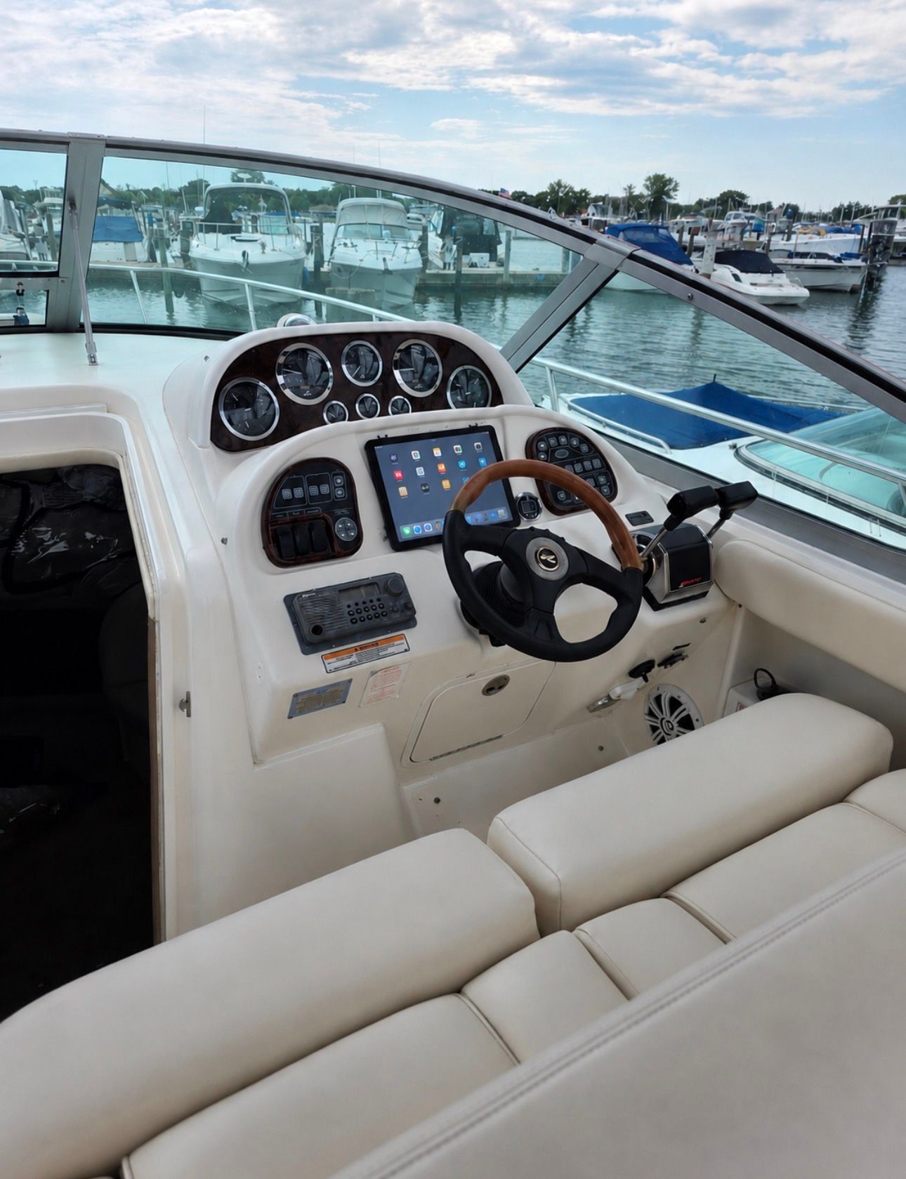 The cockpit of a 2002 Sea Ray 300 Sundancer with a modern helm station.