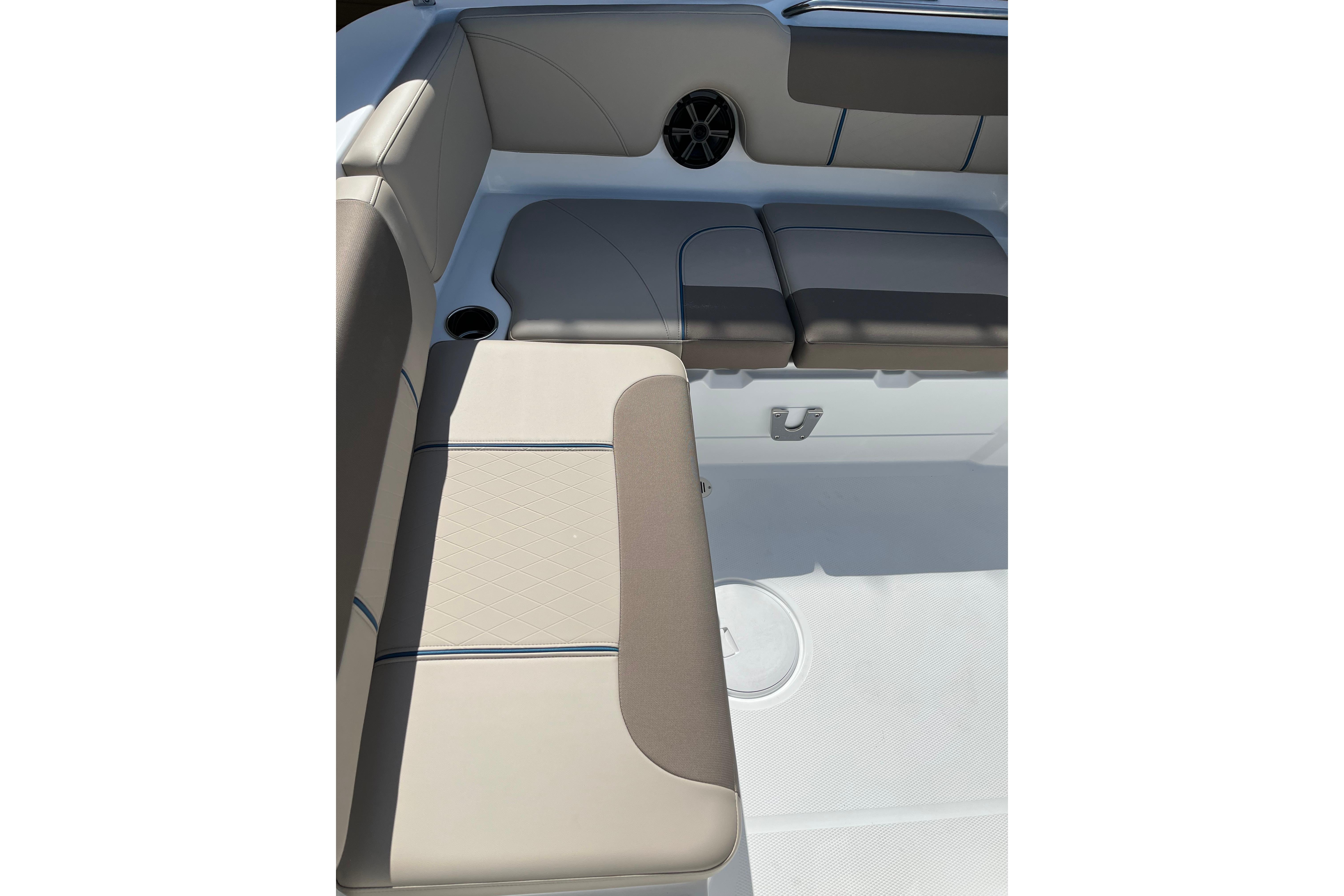 2026 Tahoe 1950 boat interior with beige seating and cup holder.
