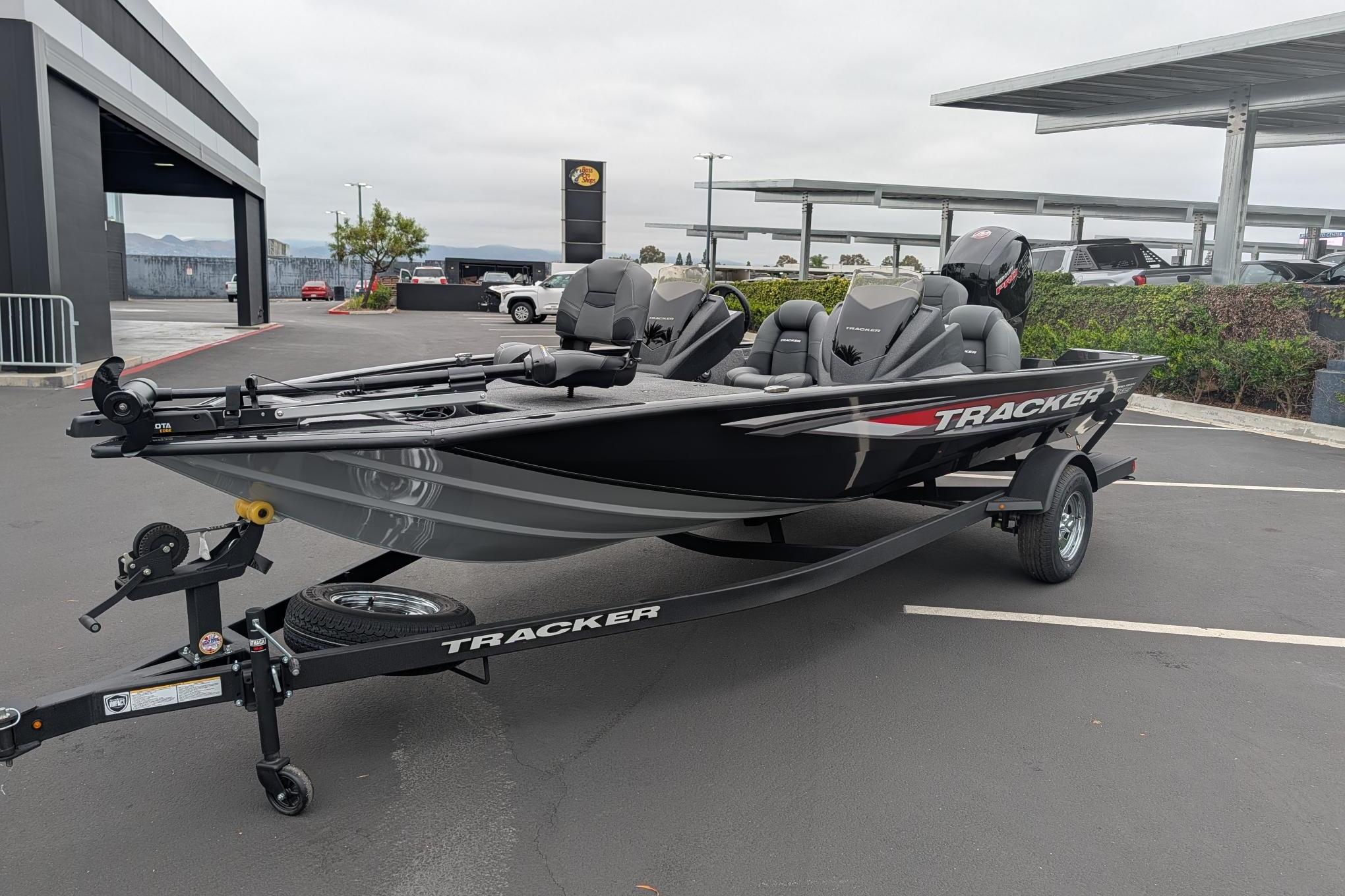 2026 Tracker Pro Team 195 TXW boat on trailer in parking lot.