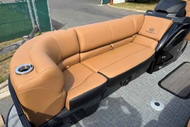 Luxurious tan seating on 2026 Regency 230 DL boat, featuring cup holder and sleek design.