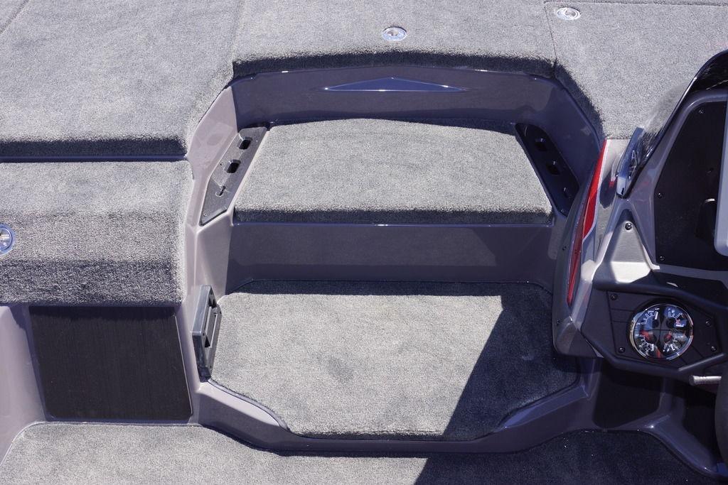 Interior view of 2026 Skeeter ZXE21 boat with carpeted steps and dashboard details.