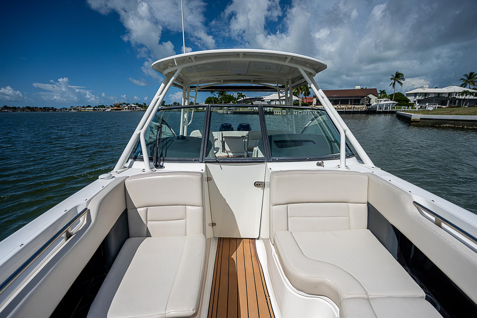 2018 Boston Whaler 270 Vantage boat interior with seating, on a sunny day by the water.