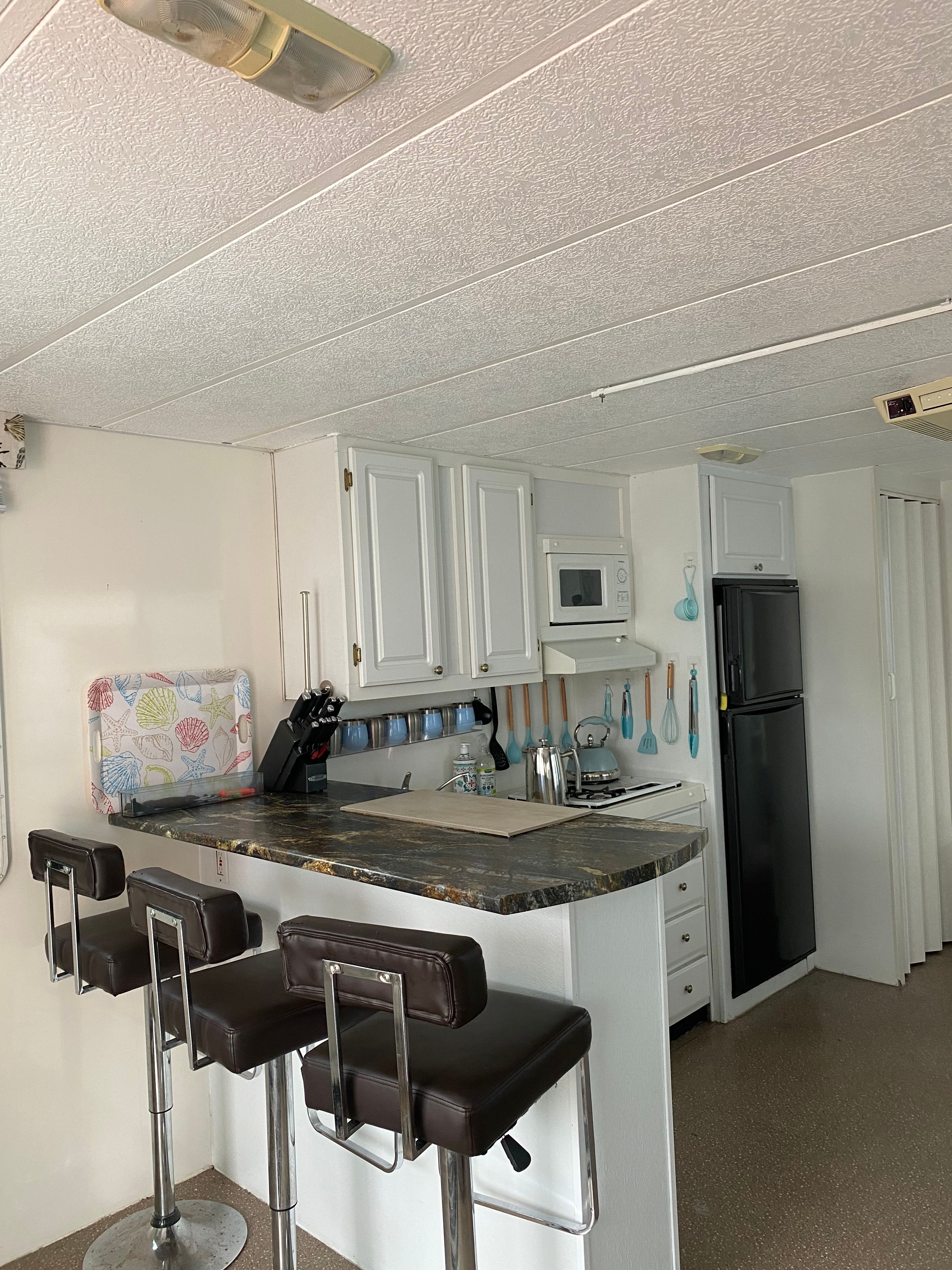 Interior of a 2004 42 ft Catamaran Cruiser with a modern kitchen and bar stools.