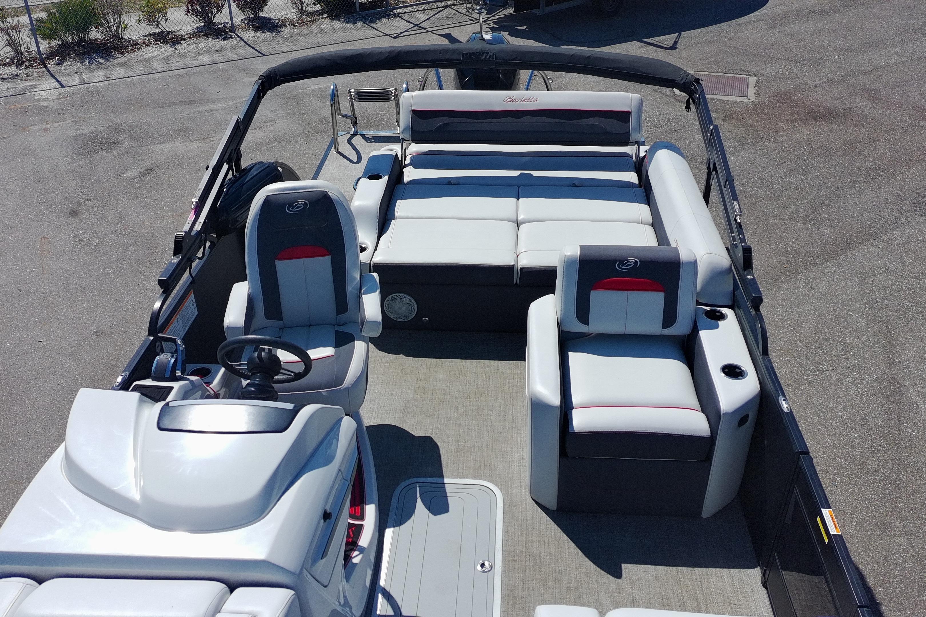 2022 Barletta Corsa 23U pontoon boat interior with plush seating and steering console.