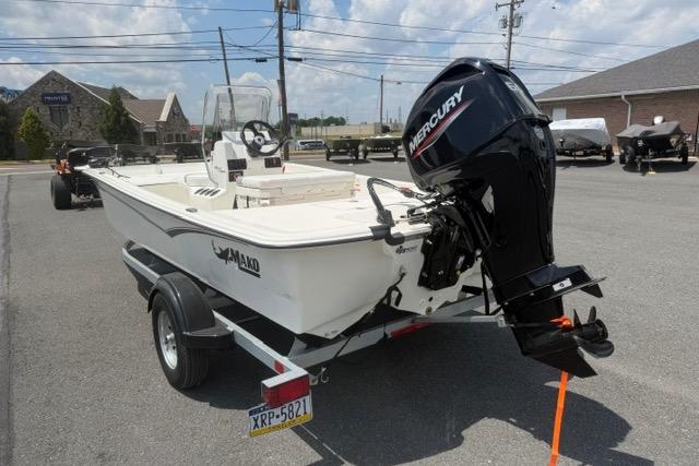 2025 Mako Pro Skiff 17 CC boat with Mercury outboard motor on a trailer.