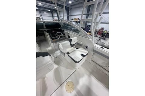 2022 Robalo R247 Dual Console boat interior with white seating and steering wheel.