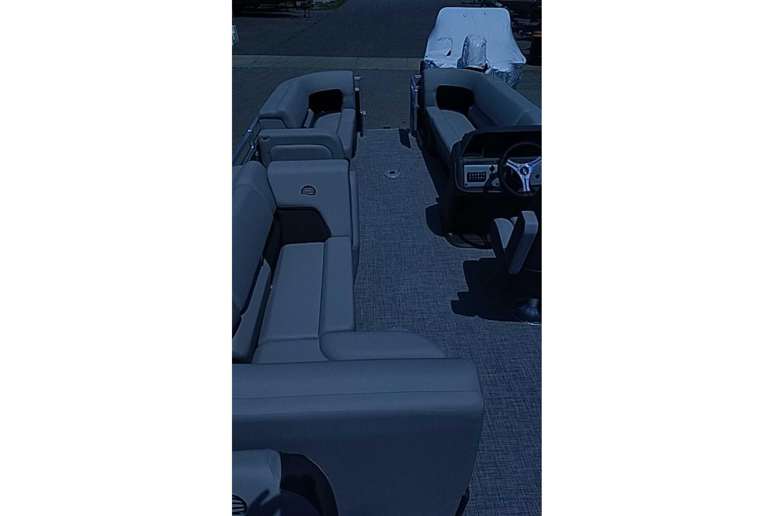 2026 Sun Tracker SportFish 22 DLX pontoon boat interior with spacious seating and steering console.