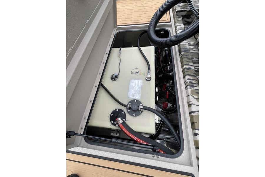 Fuel tank compartment of 2026 Avid 21 FSX boat, showing hoses and wiring.