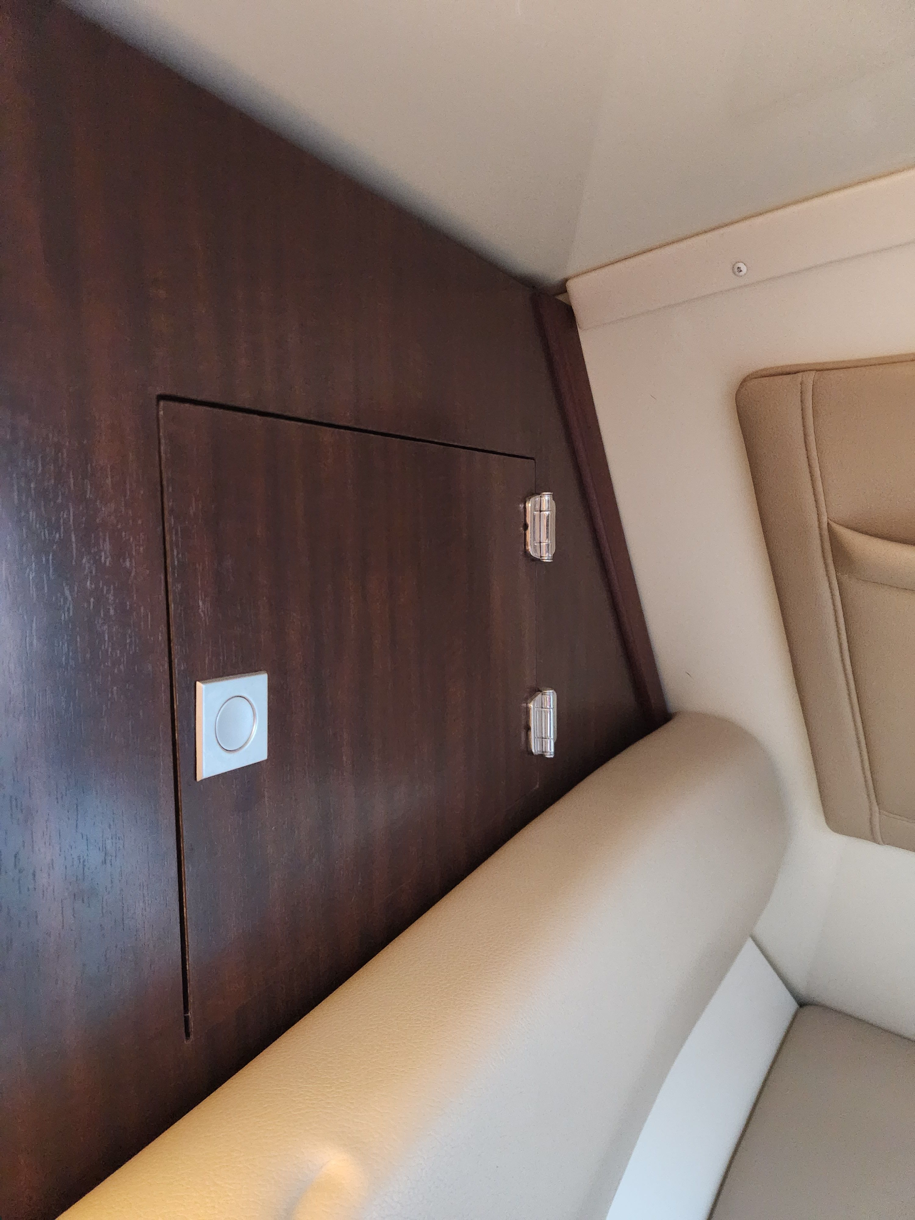 Interior of a 2015 Monterey 268SSC boat, featuring wood panel and upholstery.