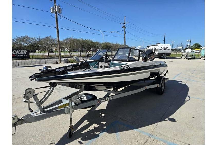 1997 Javelin 389 FS boat on trailer in outdoor parking lot.