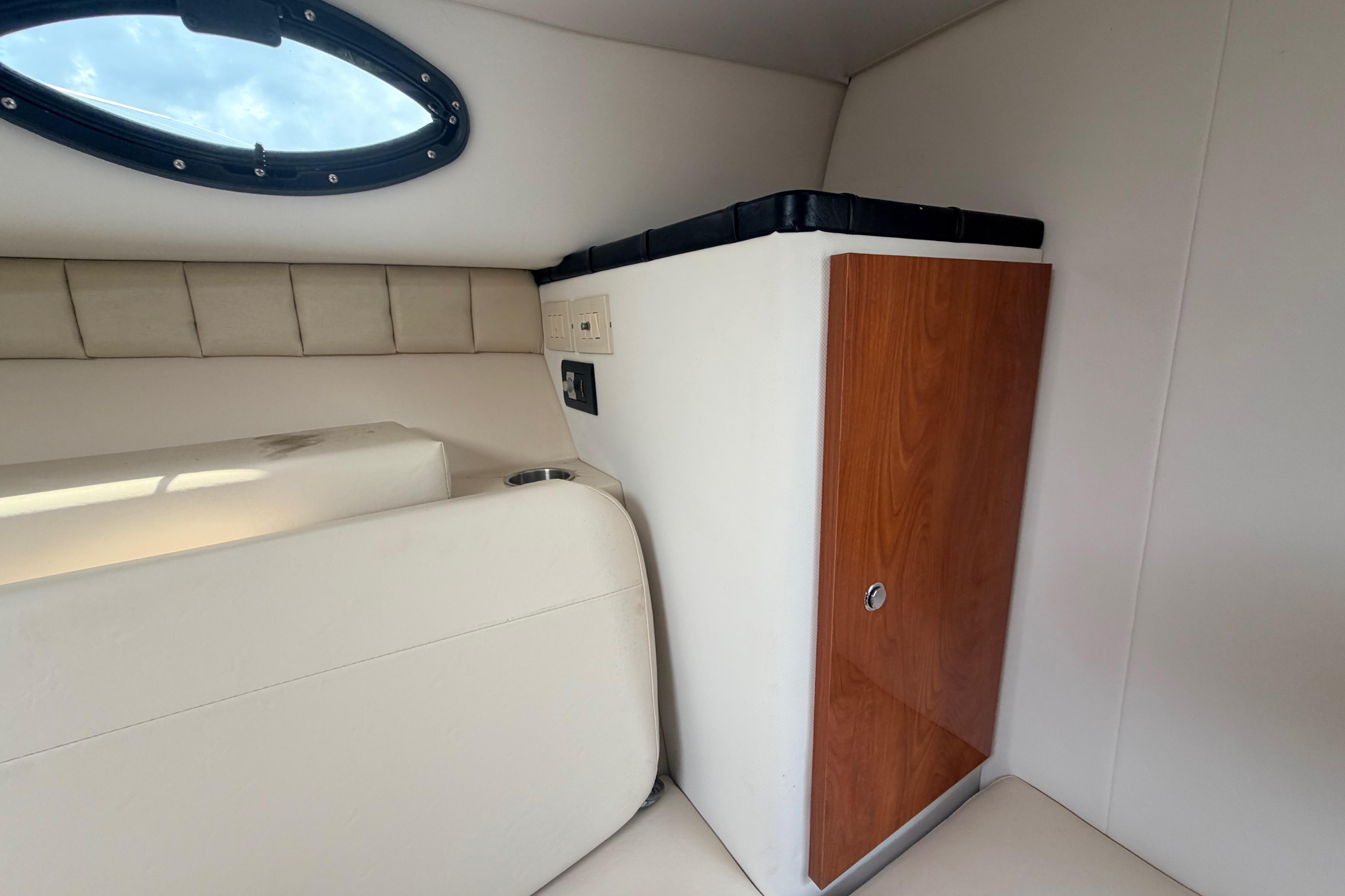 Interior cabin of 2015 Wellcraft 290 Coastal boat with seating and storage.