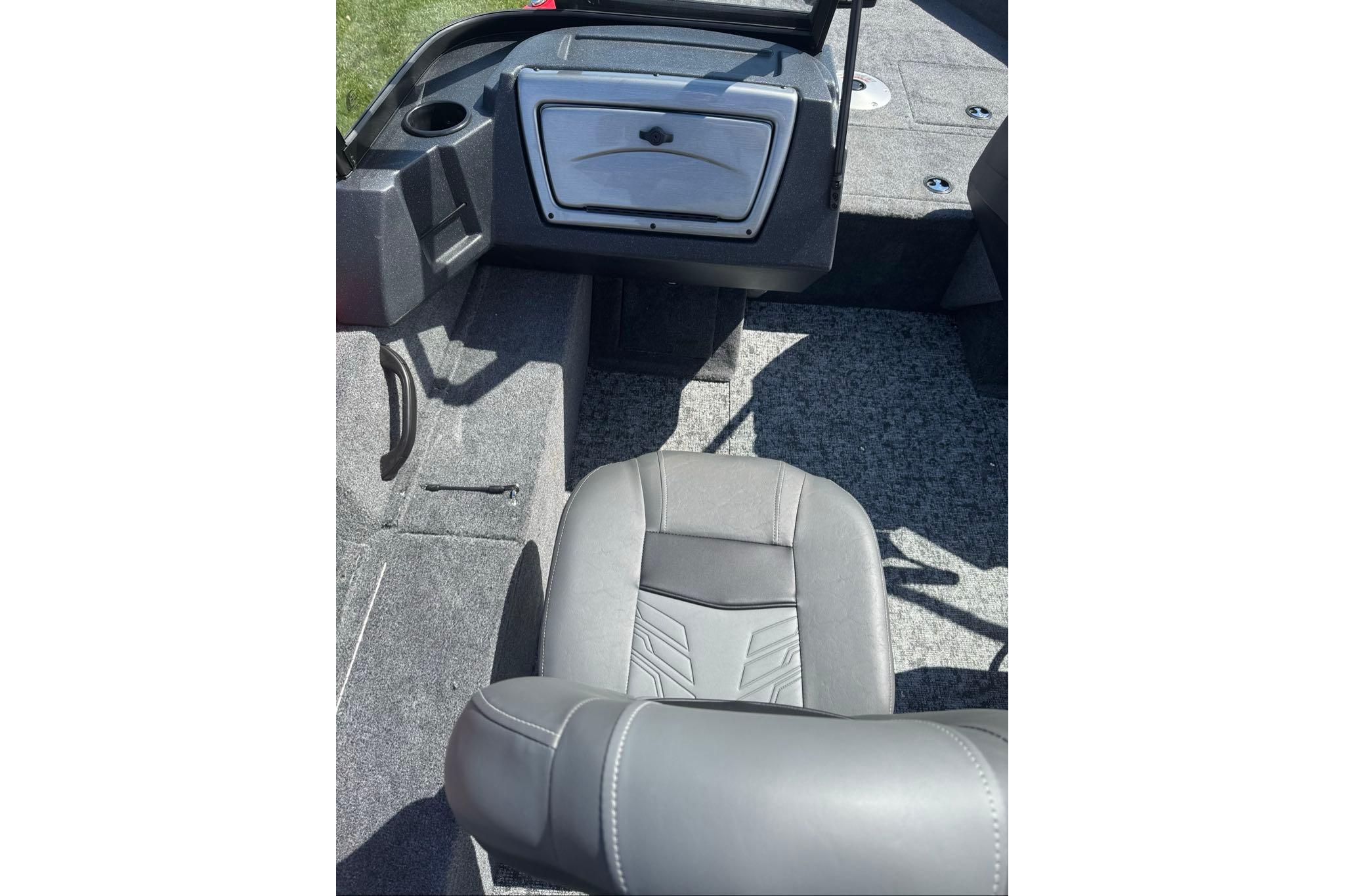 2026 Tracker Pro Guide V-16 WT boat interior with gray seating and storage compartment.