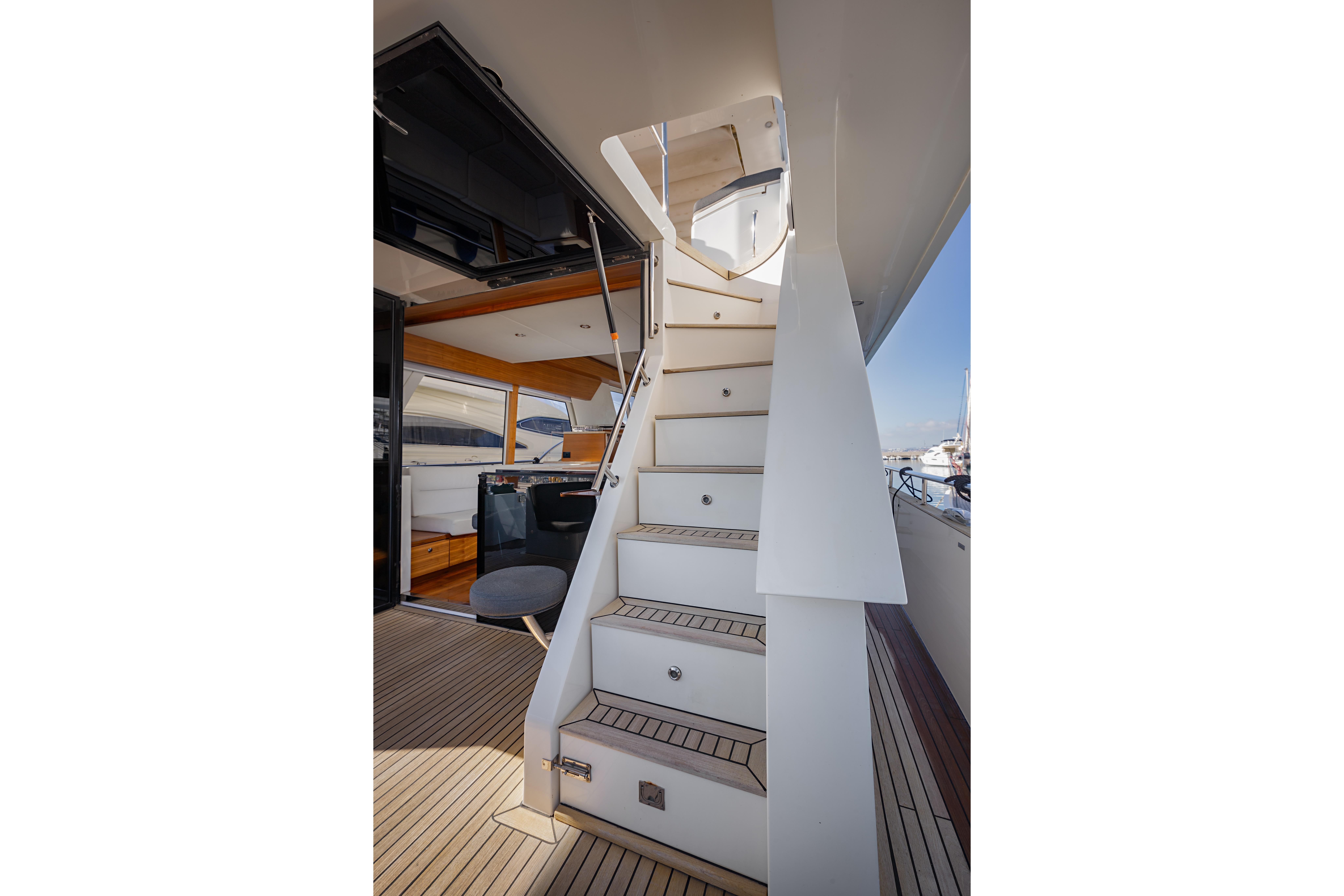 Staircase on 2016 Outer Reef Trident 620 yacht, leading to upper deck.