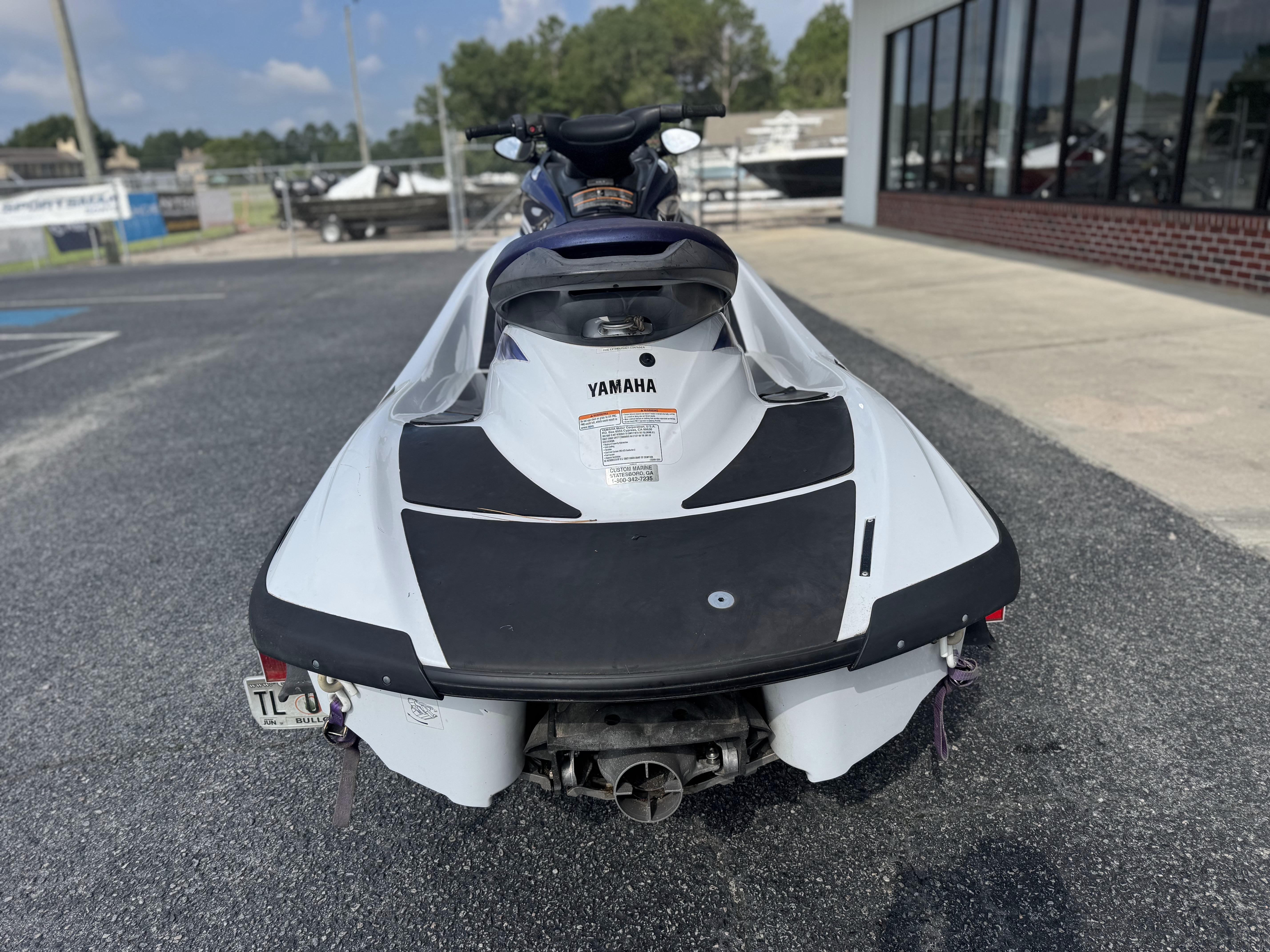2003 Yamaha WaveRunner FX140 jet ski parked outdoors, rear view.