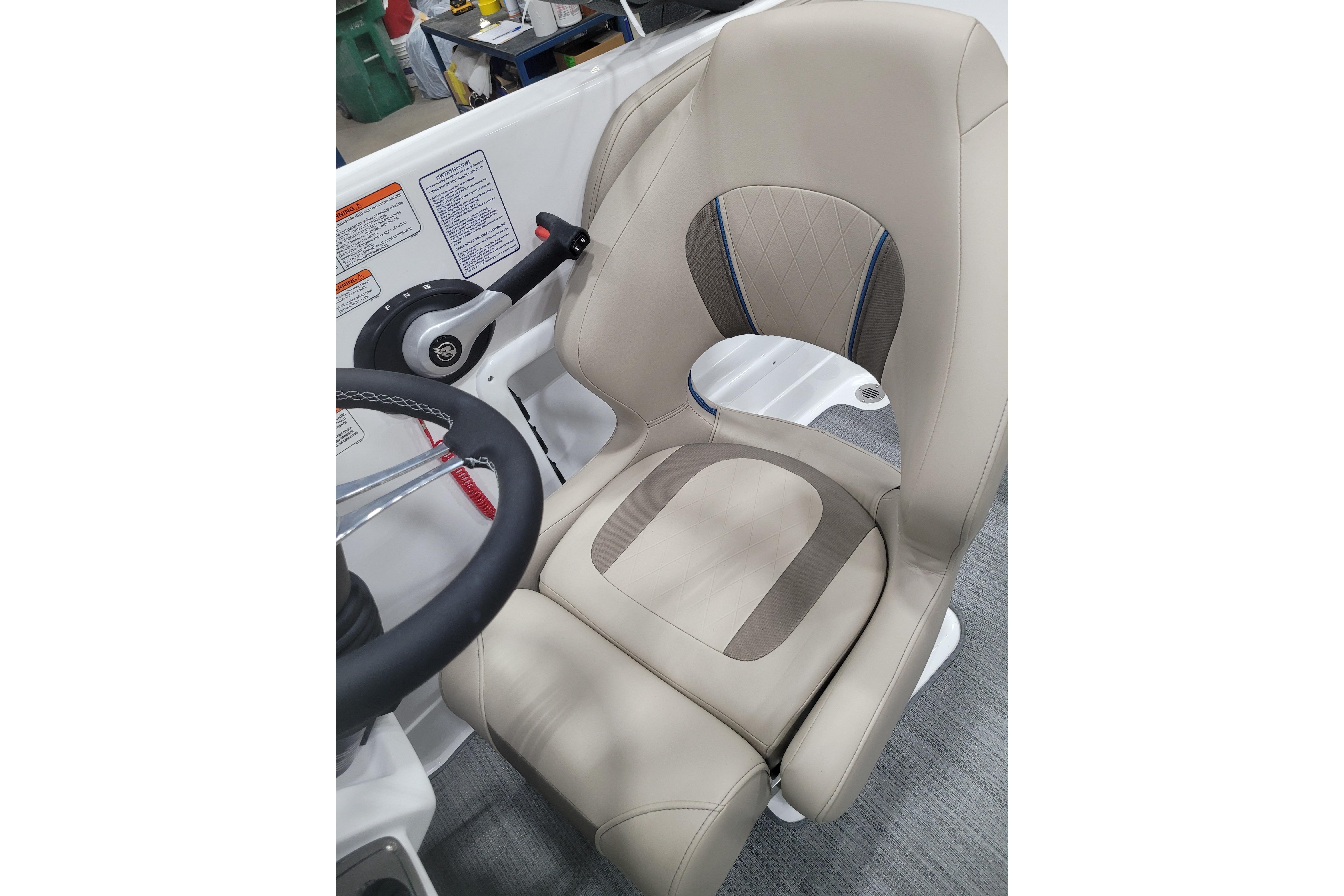 2026 Tahoe 2150 boat captain's seat with beige upholstery and steering wheel.