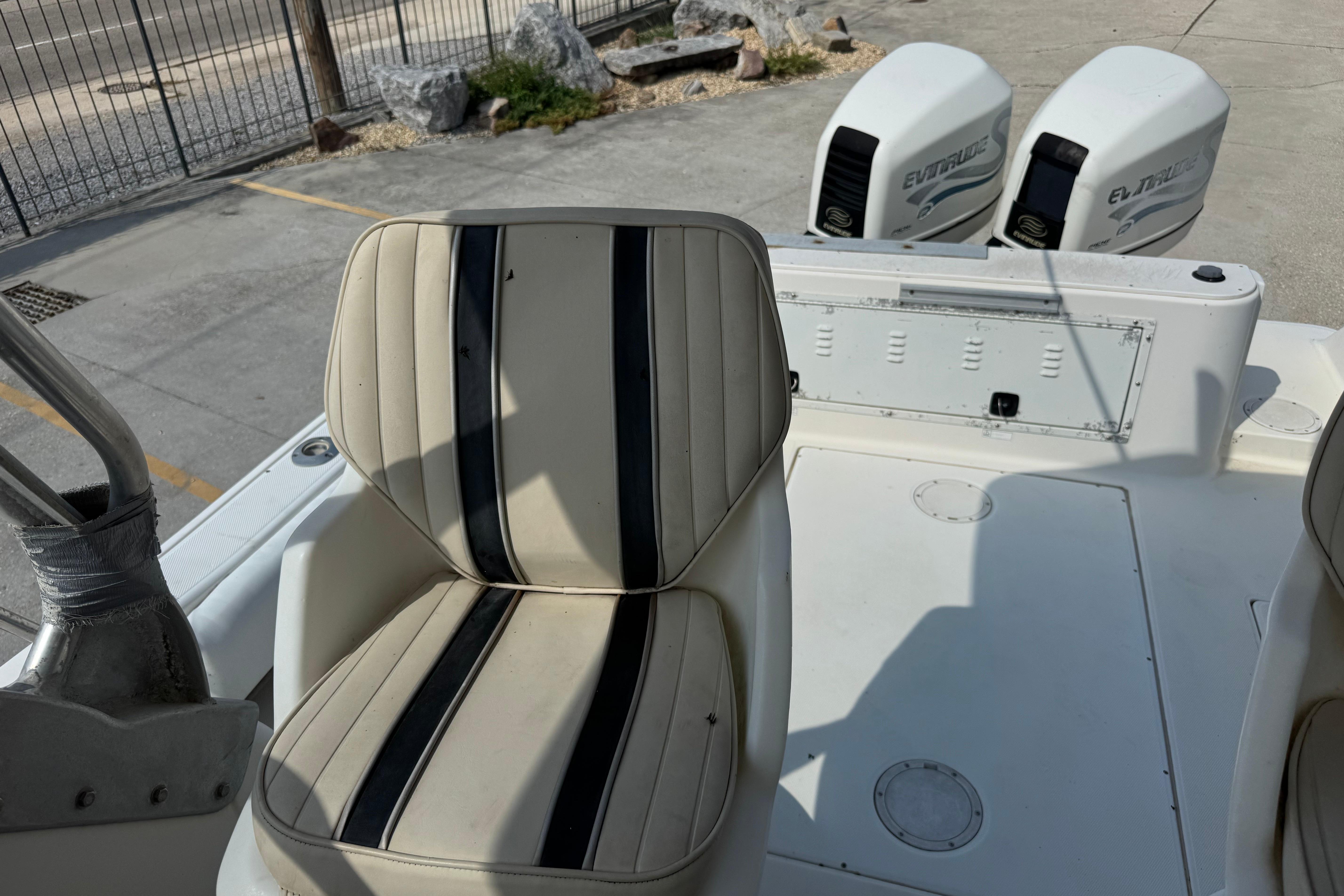1997 Hydra-Sports VECTOR 2650 WA boat interior with striped seating and dual Evinrude engines.