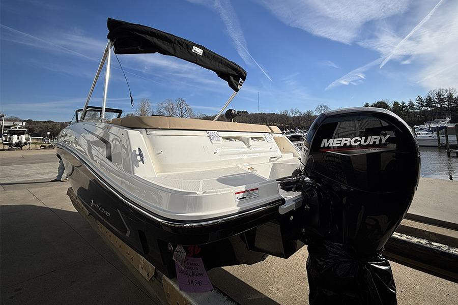 2023 Bayliner VR5 Bowrider OB with Mercury outboard motor at marina dock.