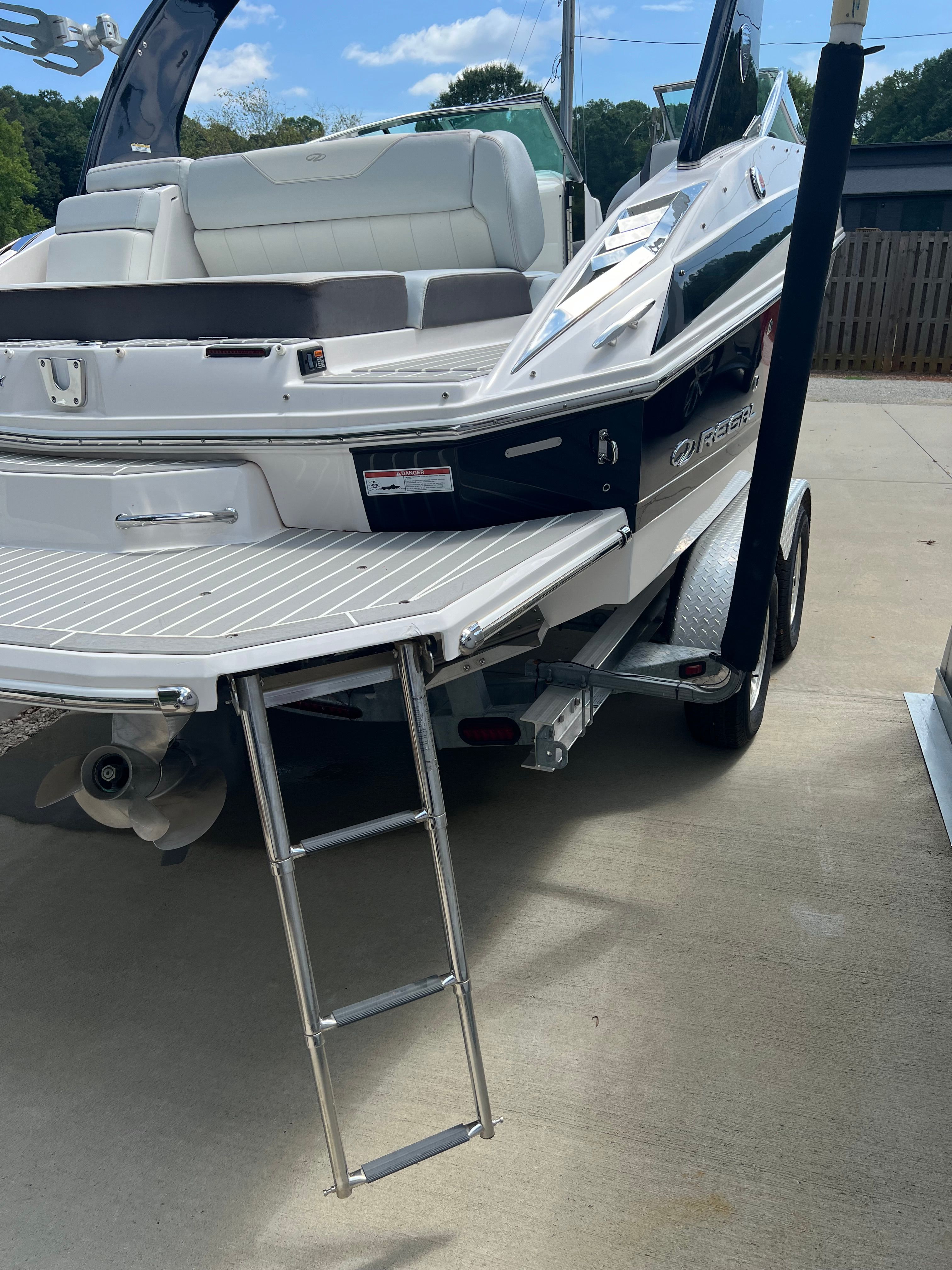 2014 Regal 24 FasDeck RX boat with ladder on trailer.