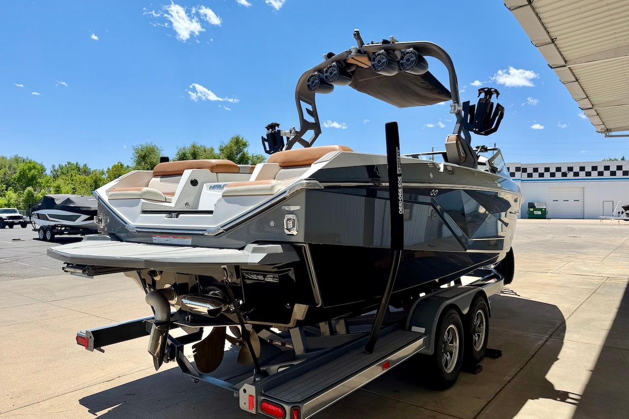 2021 Nautique Super Air Nautique G23 boat on trailer under clear blue sky.