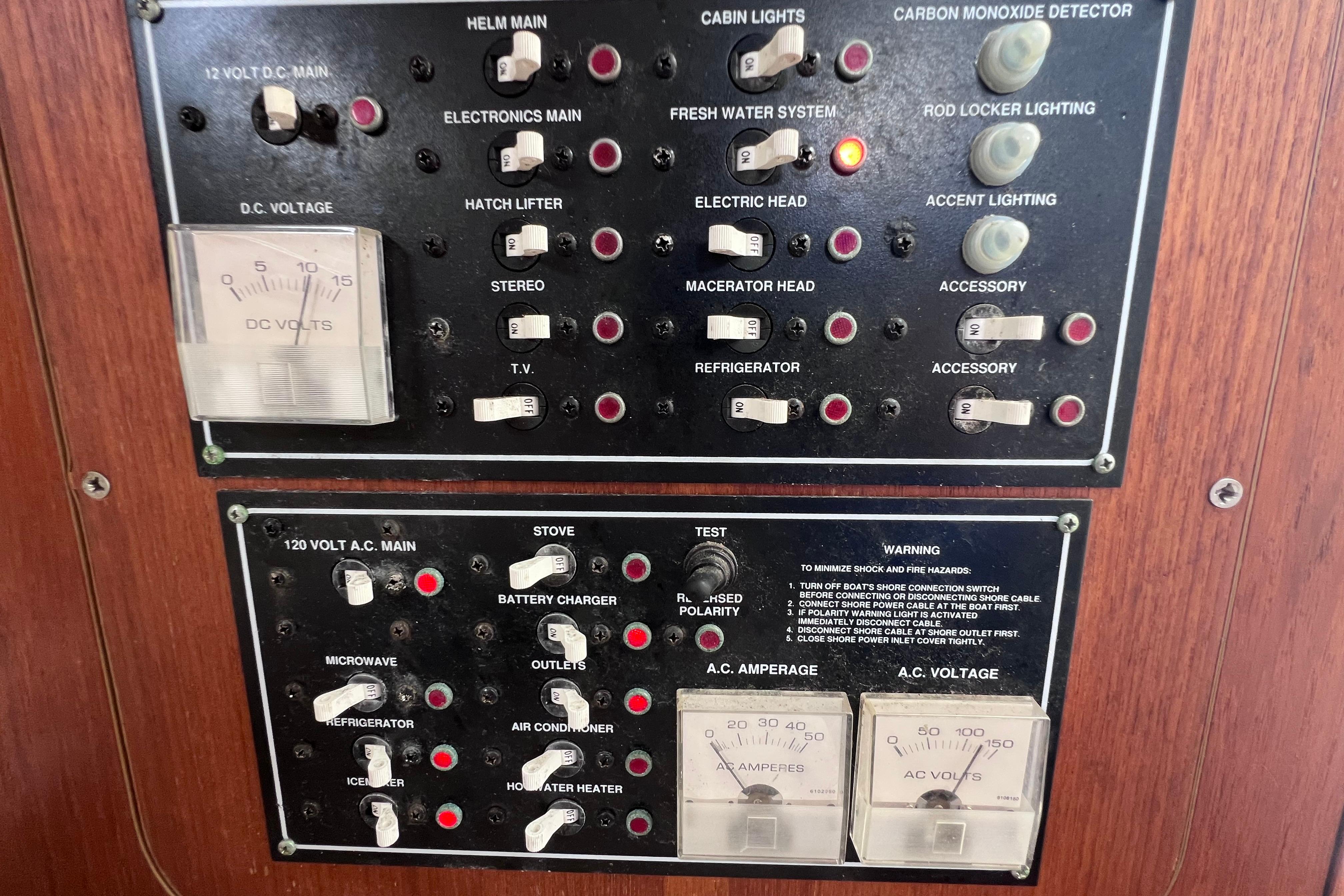 Electrical control panel on a 2005 Pursuit 3070 Offshore boat, featuring various switches and gauges.