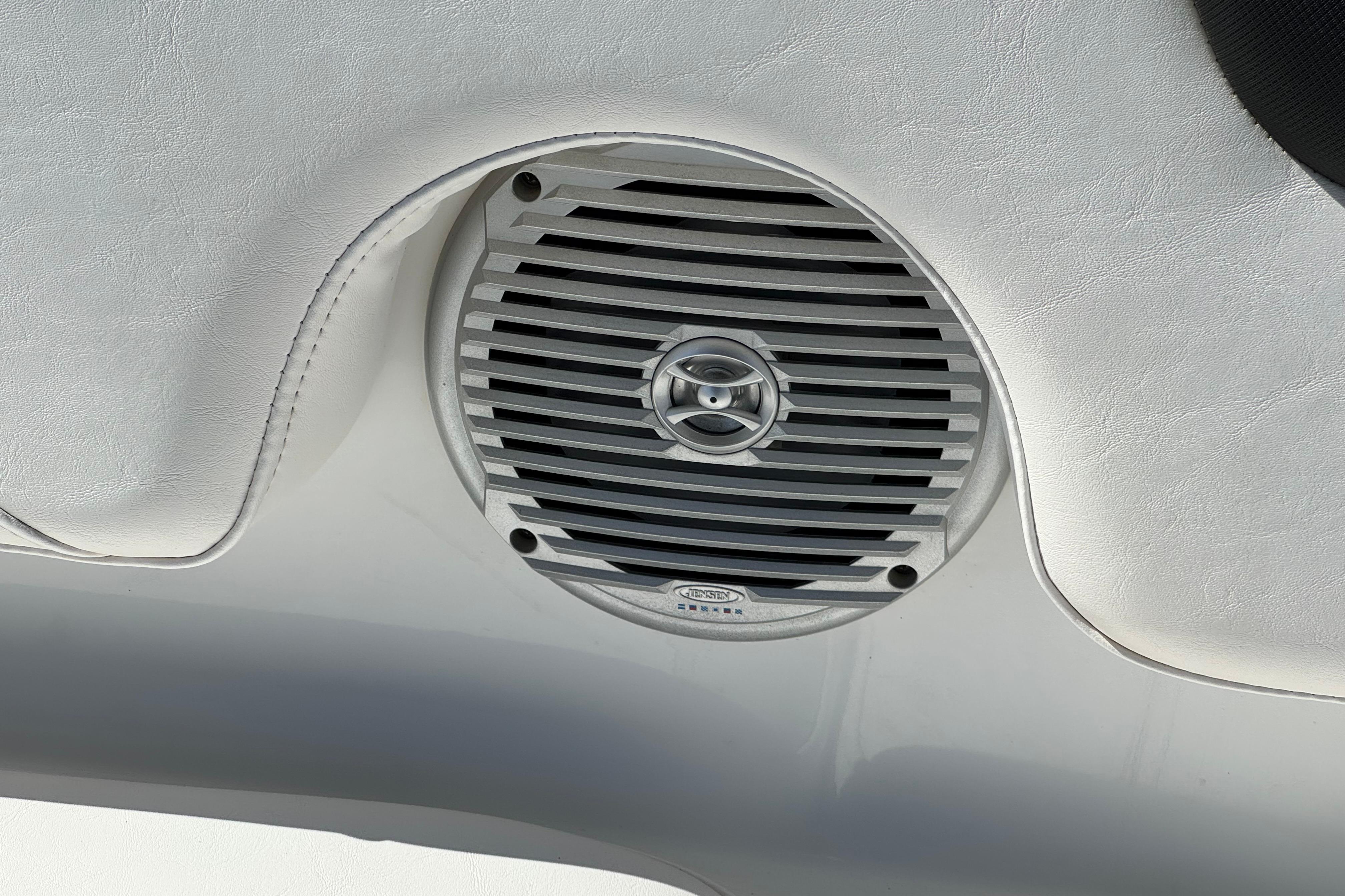 Speaker detail in 2019 Tahoe 2150 boat interior, featuring sleek design and white upholstery.