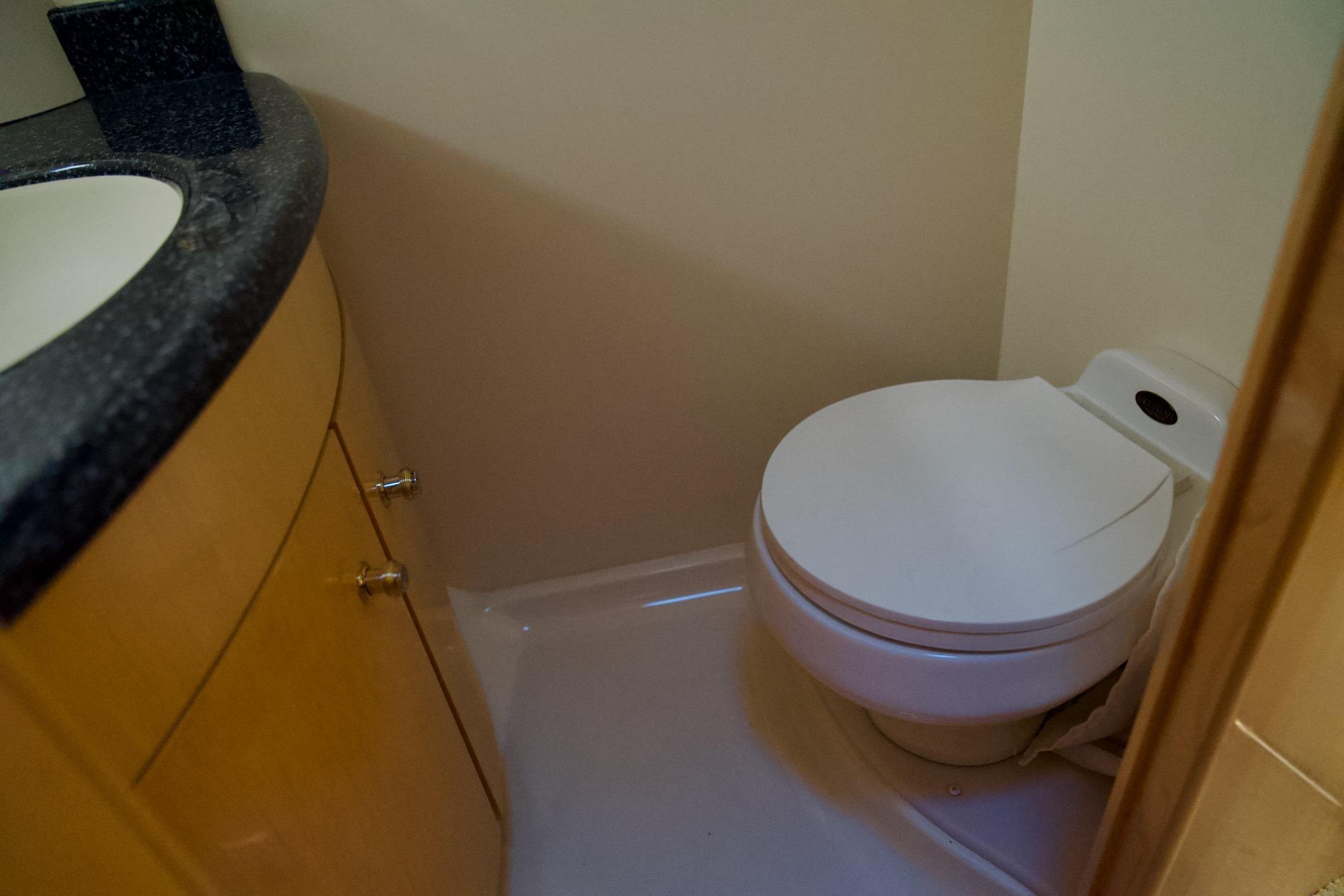 Bathroom interior of 2000 Carver 506 Motor Yacht with toilet and sink.