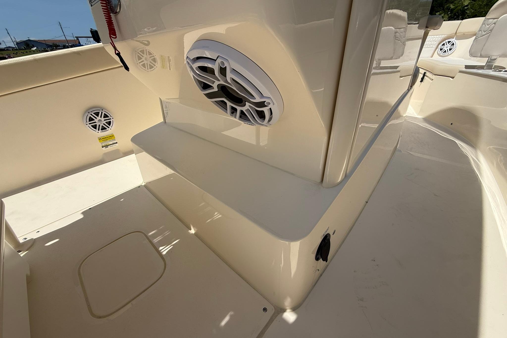 2027 Scout 240 XSF boat interior with speakers and seating area.