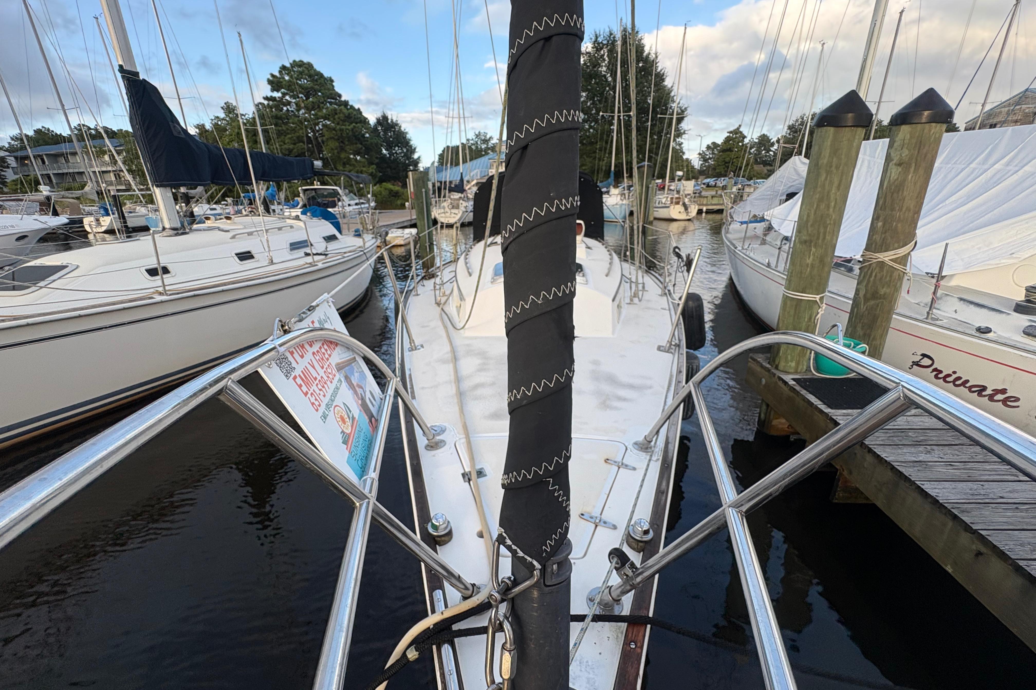 1981 Sabre 31 sailboat docked at marina, surrounded by other boats.