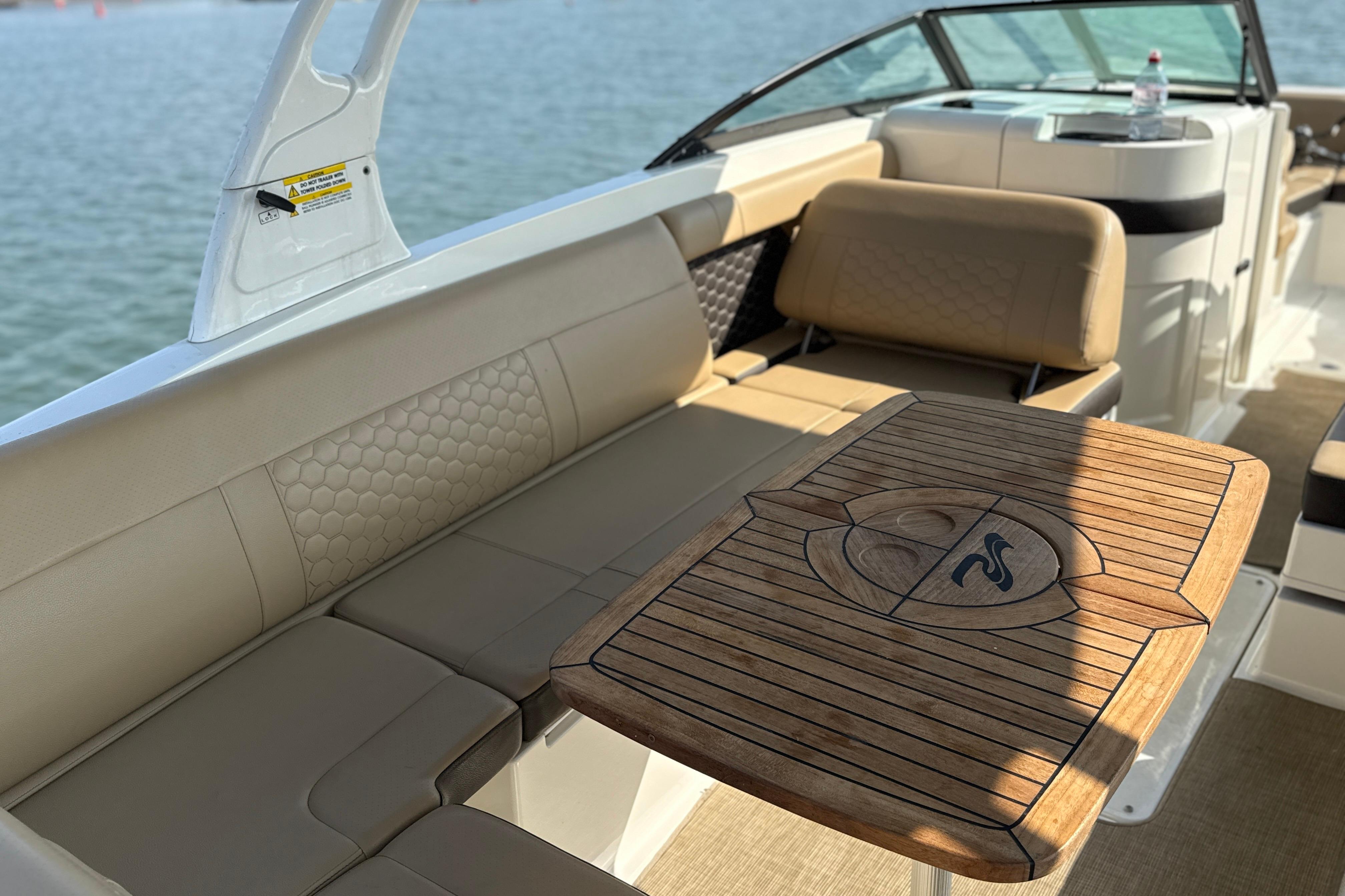 Interior of 2018 Sea Ray 270 SDX boat with elegant seating and wooden table.