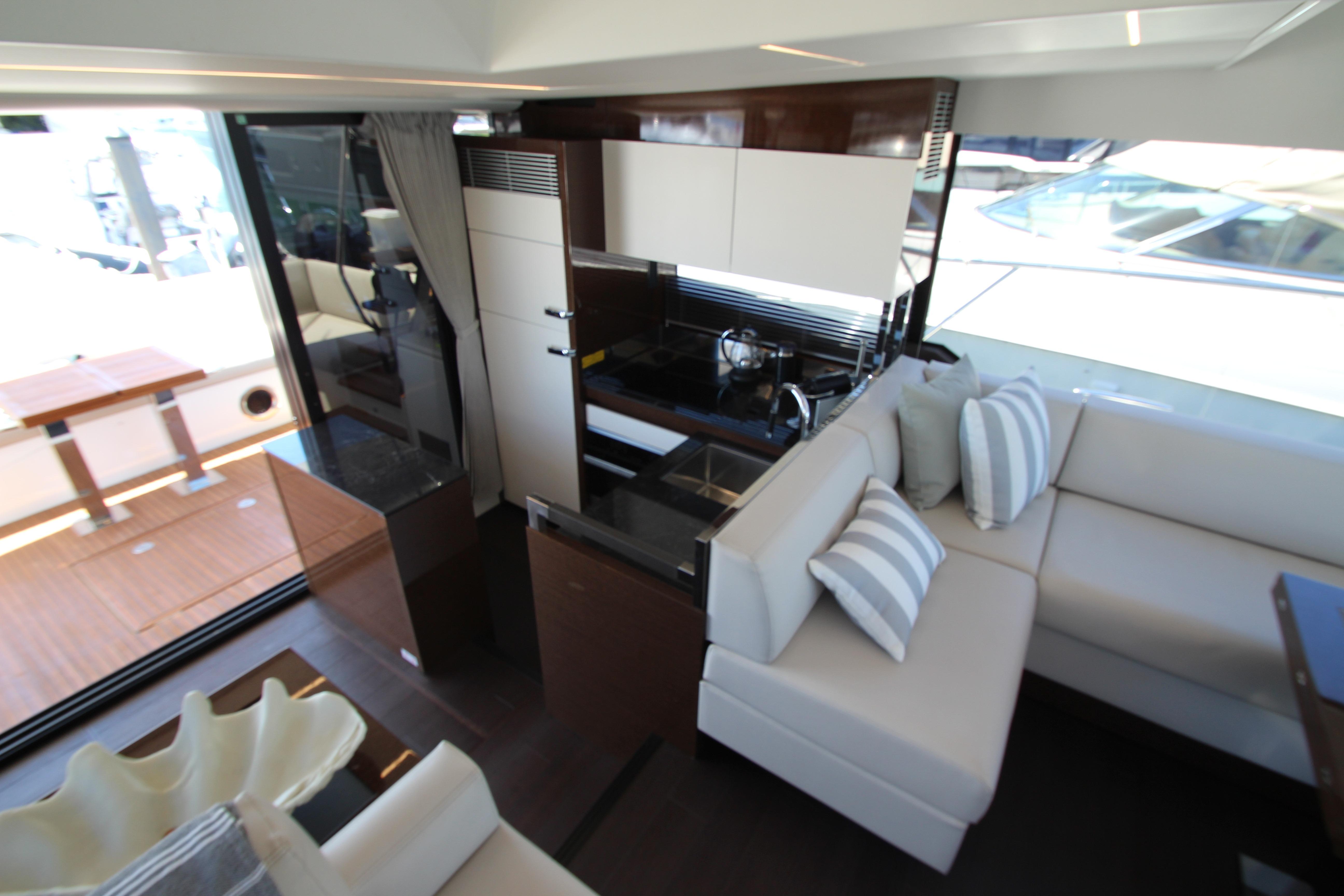 Luxurious interior of 2022 Prestige 520 yacht with modern kitchen and comfortable seating.