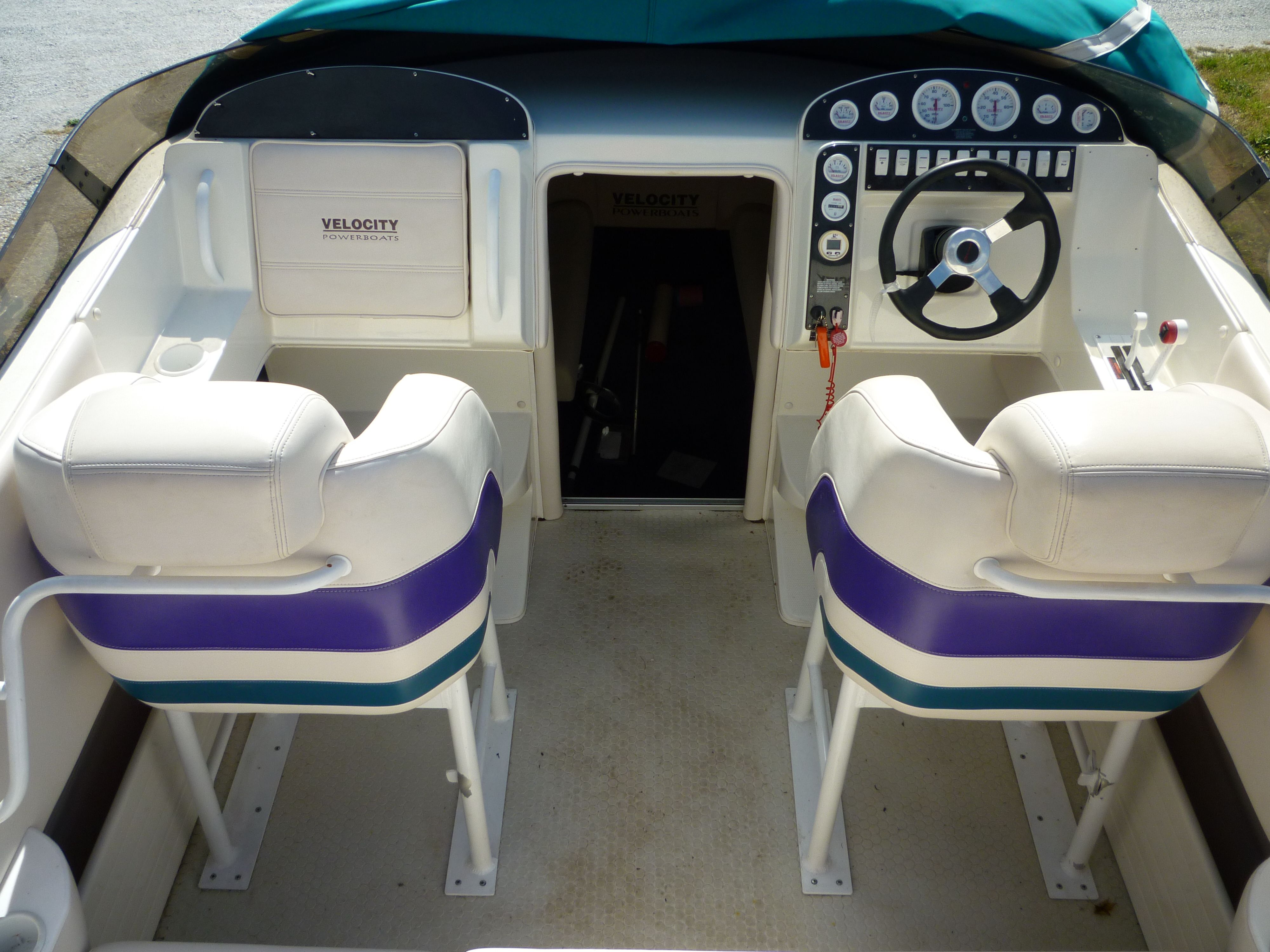 Interior of a 2000 Velocity 280 powerboat with dual seats and control panel.