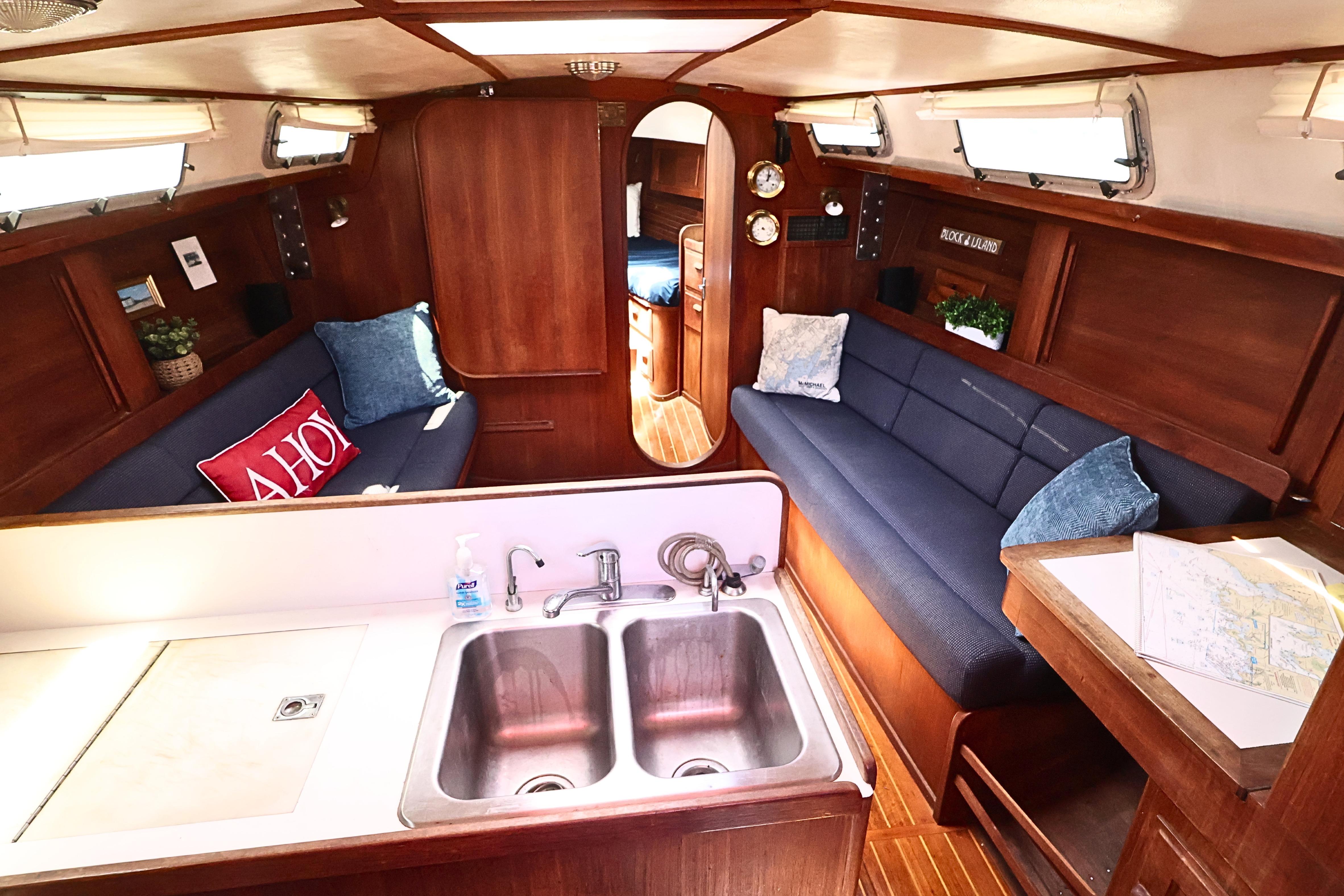 Interior of 1989 J Boat J 40 sailboat with cozy seating and wooden finishes.