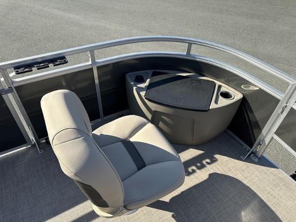 Sun Tracker FB 20 DLX 2025 boat interior with beige seating and storage area.