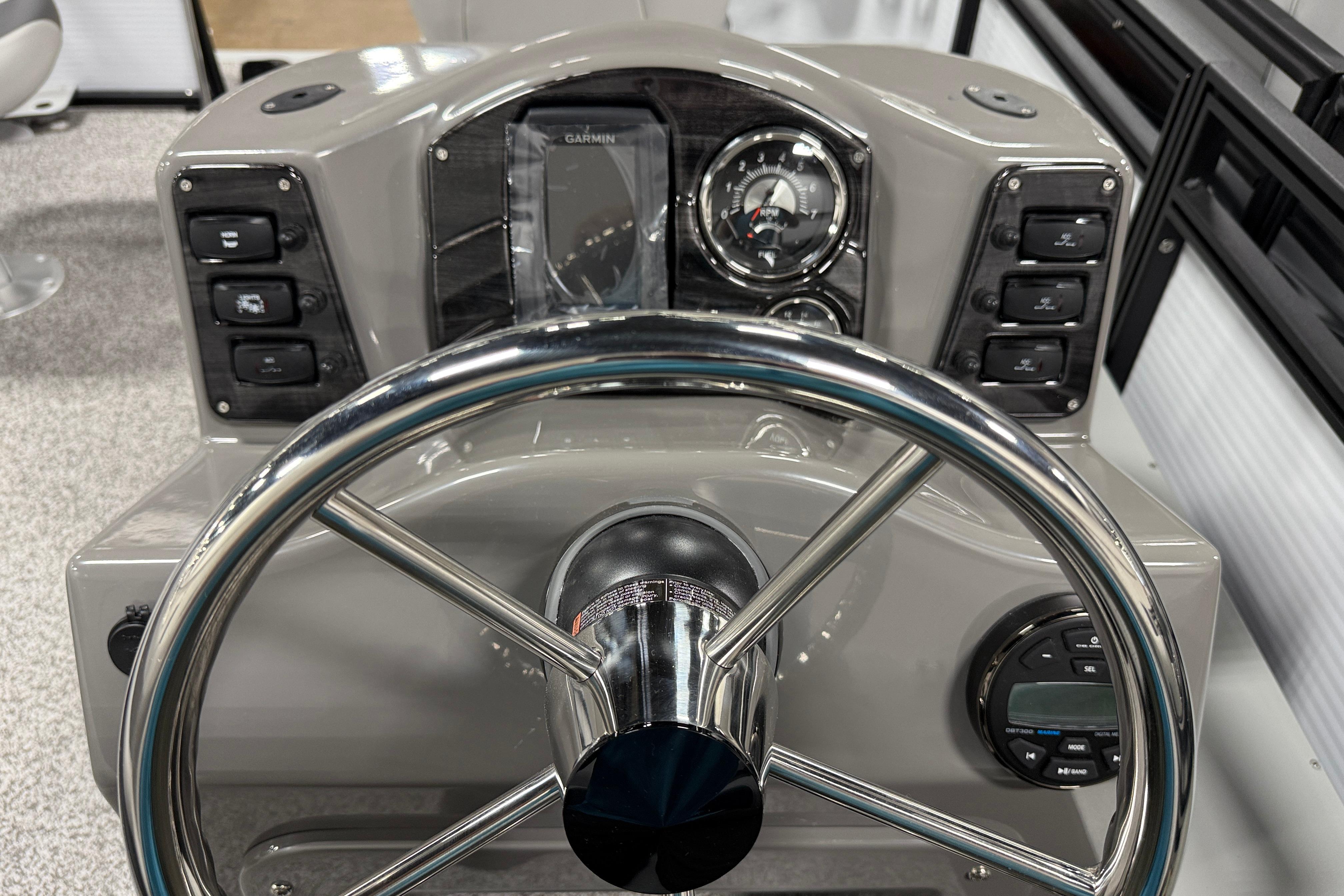 Steering console of 2026 Angler Quest 816 Panfish boat with controls and gauges.