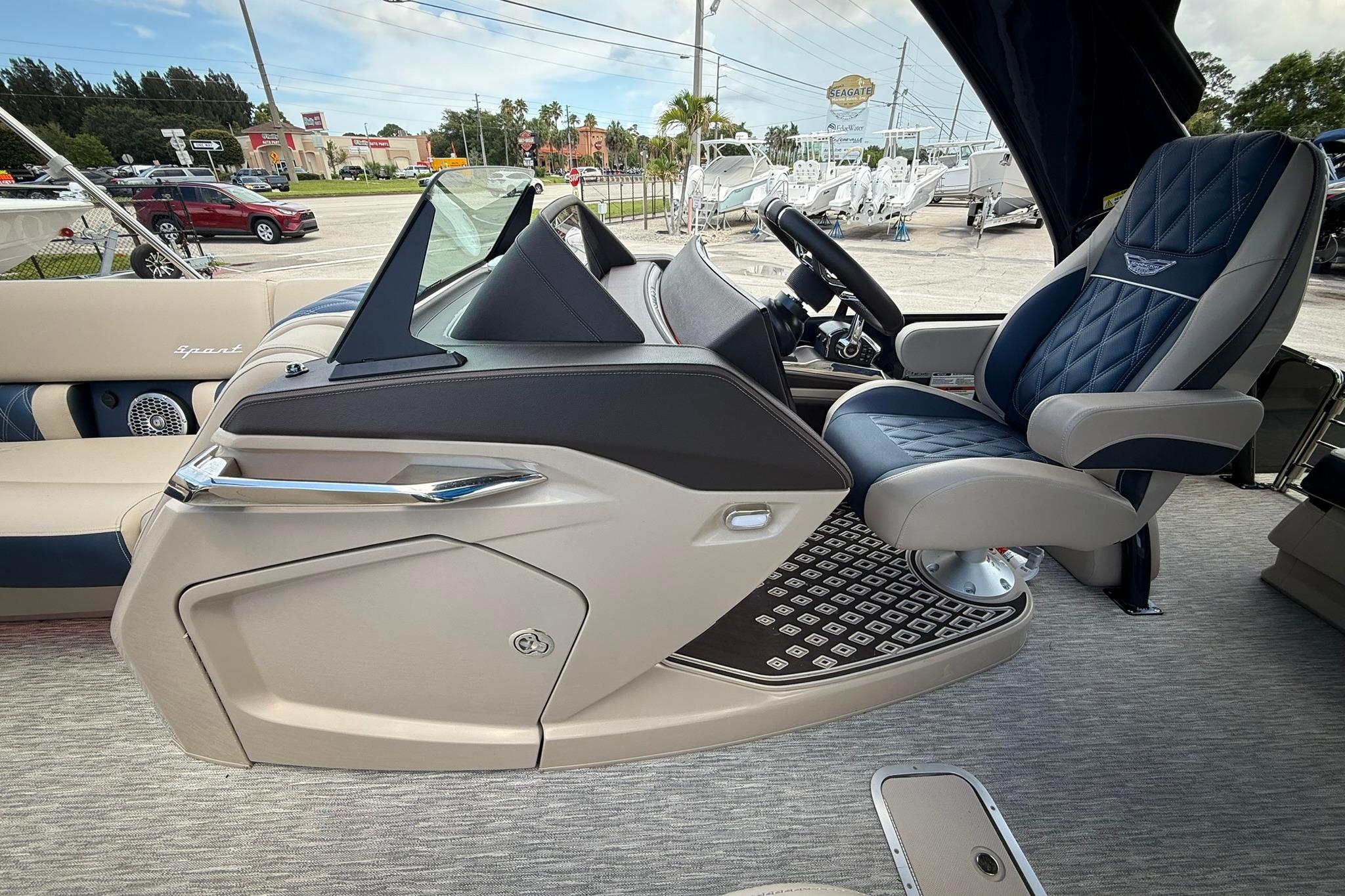 Luxurious interior of 2026 Bennington 27 QSBAT2 pontoon boat with plush seating and modern dashboard.