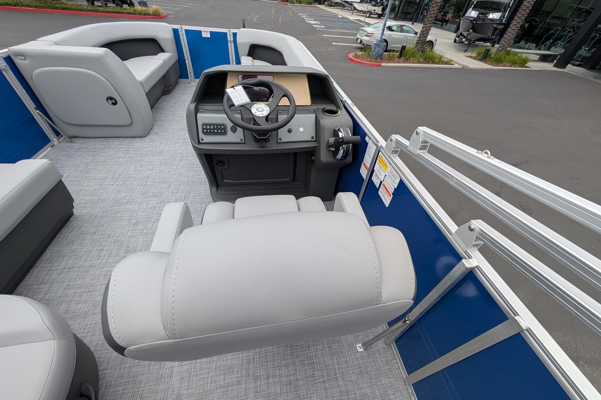 2026 Sun Tracker Party Barge 18 DLX interior with helm, seating, and modern design.