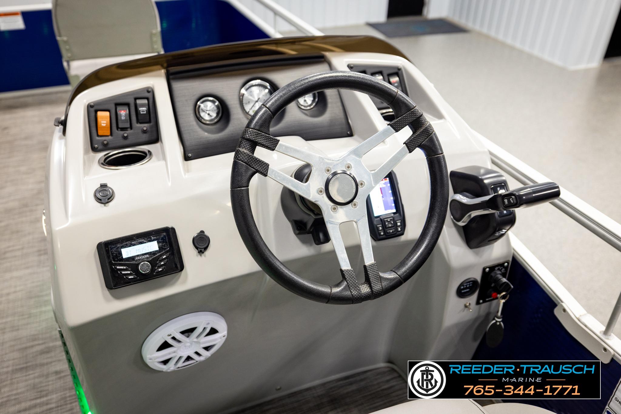 Steering console of a 2021 Bennington 20 SV pontoon boat with controls and gauges.
