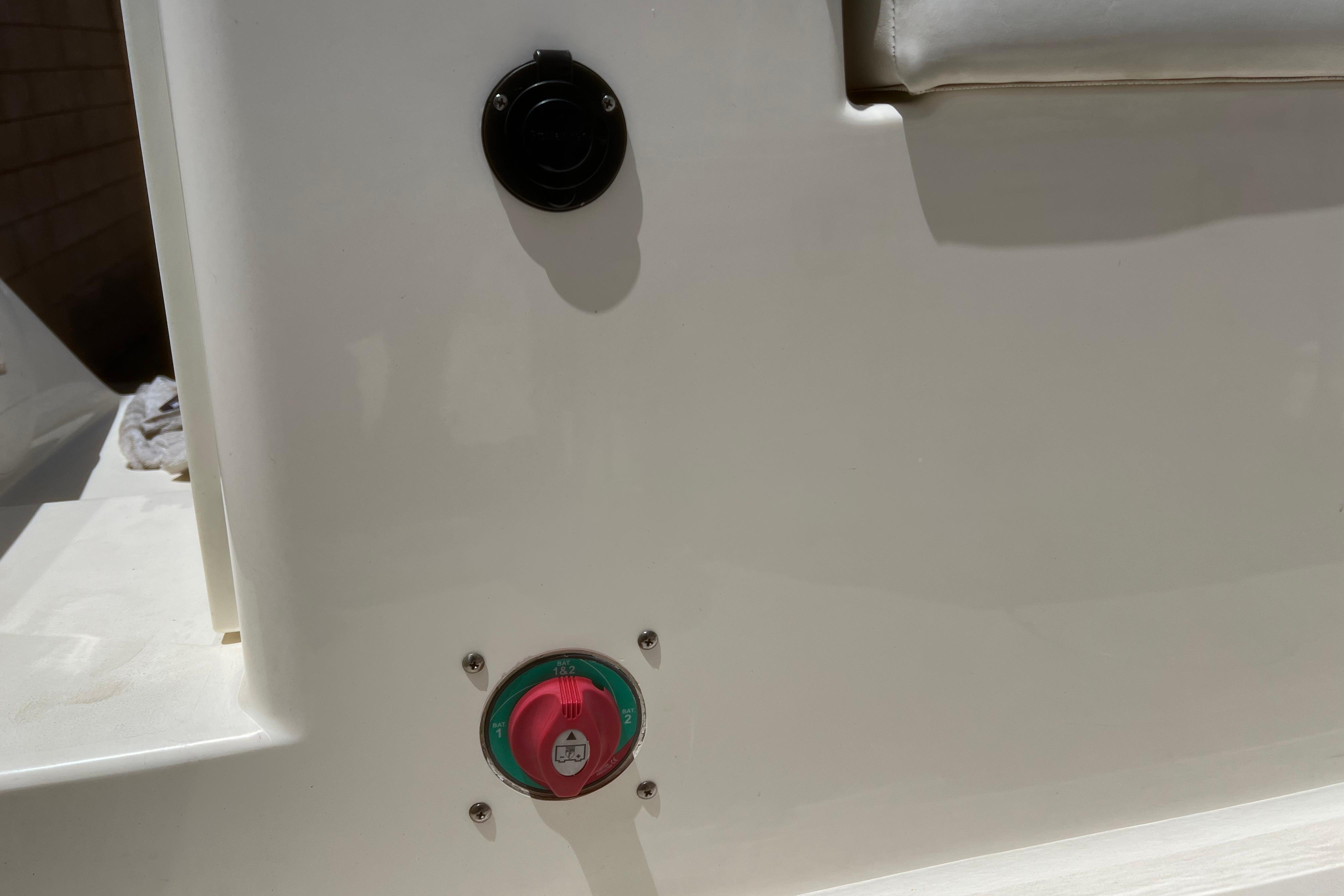 2018 Cobia 201 Center Console boat switch panel with red and green controls.