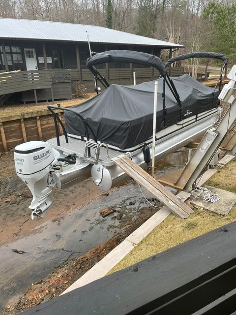 2021 Veranda VR22RC pontoon boat with Suzuki motor on land.