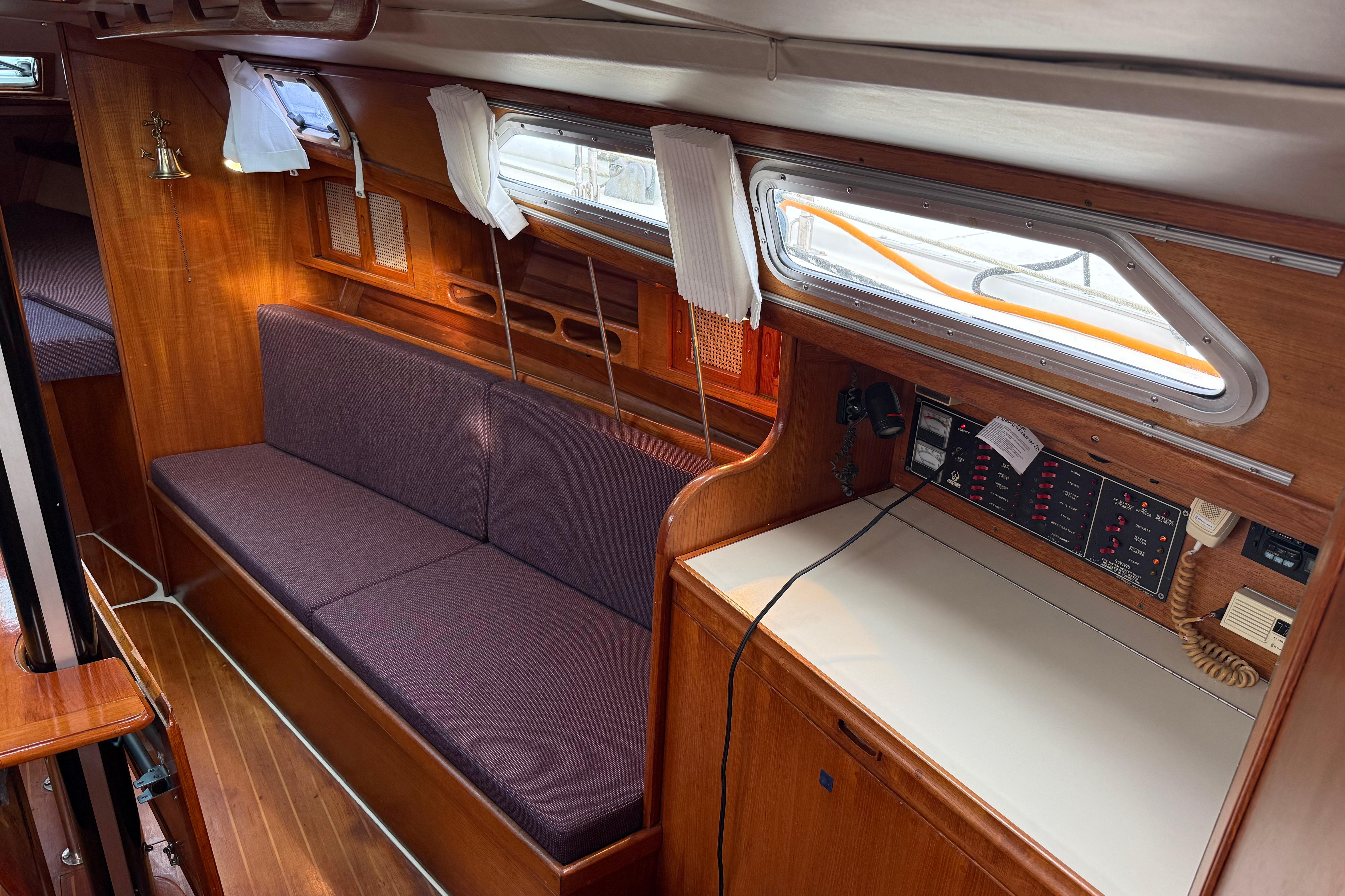 Interior of 1988 Ericson 32-200 sailboat with wood finish and navigation station.