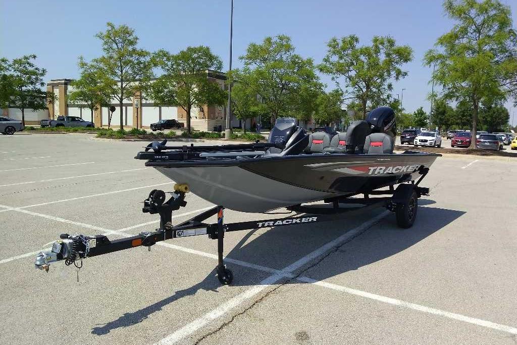 2026 Tracker Pro Team 175 Crappie Edition boat on trailer in parking lot.