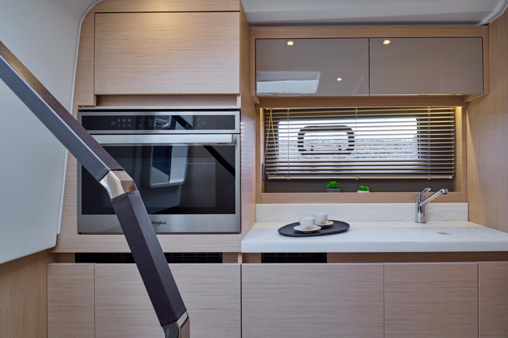 Modern kitchen interior of 2027 Jeanneau DB/43 OB yacht with sleek cabinetry and appliances.