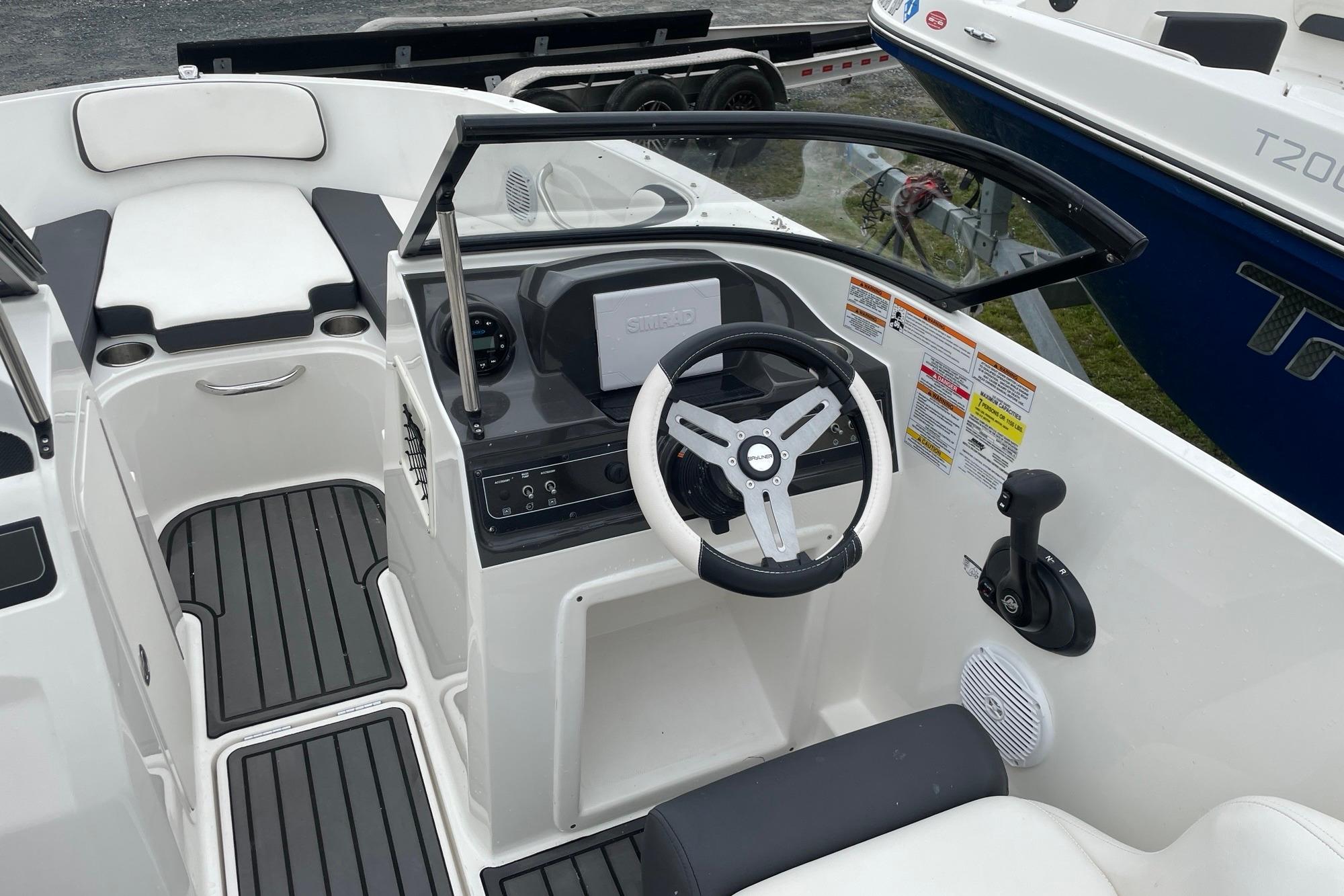 2023 Bayliner VR4 Bowrider OB interior with steering wheel and seating area.