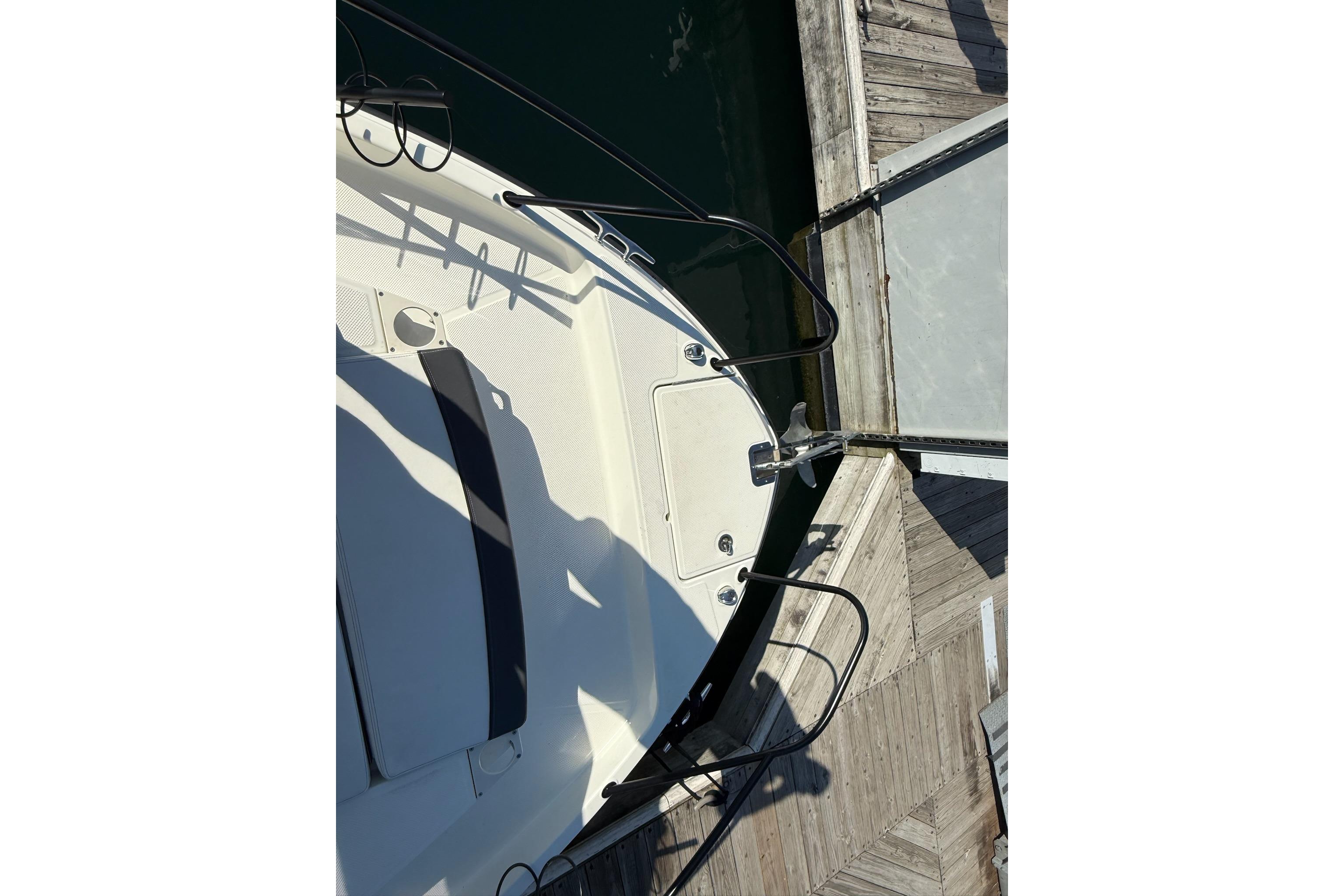 2024 Bayliner Trophy T25 Pilothouse boat docked at marina, top view.