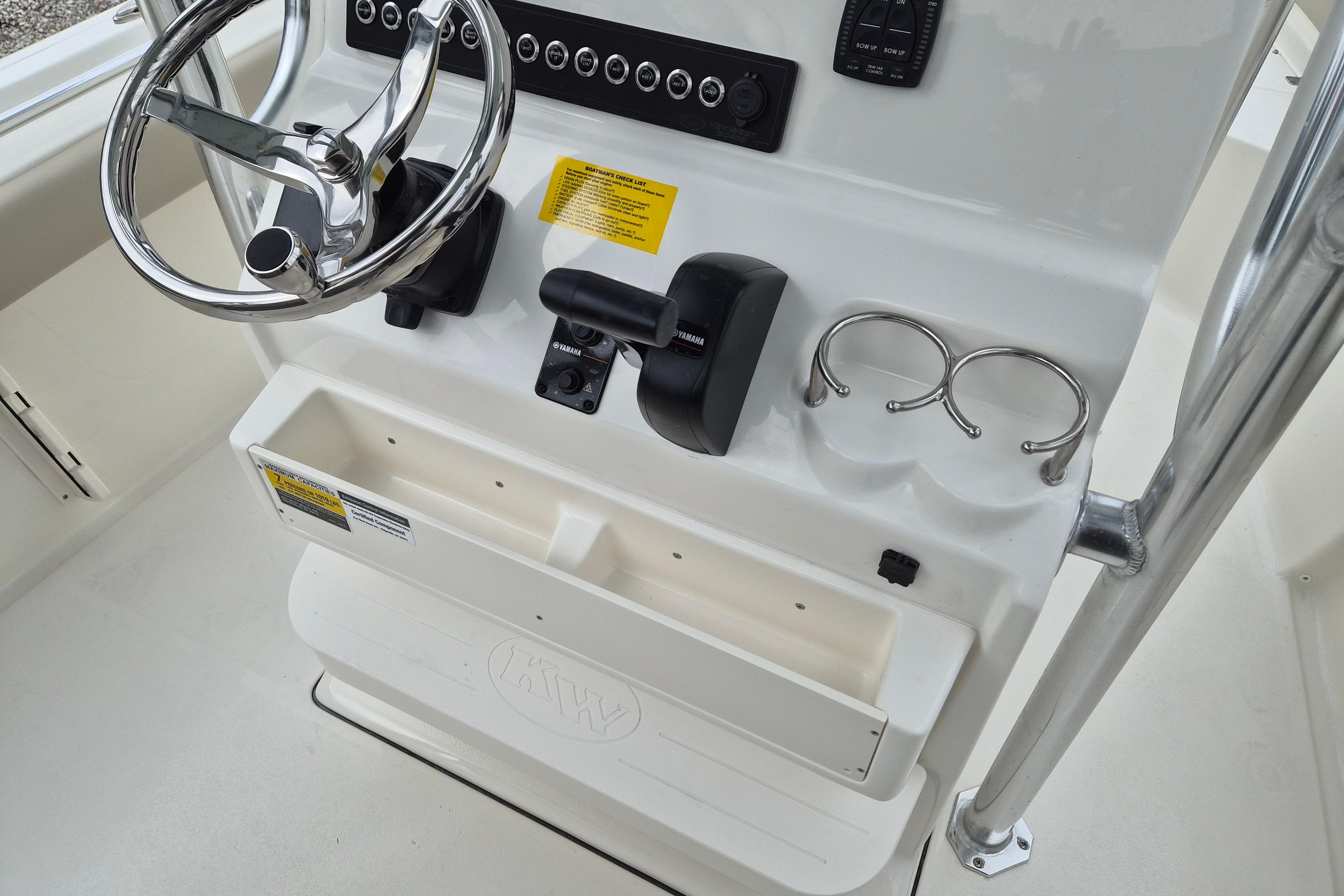 2026 Key West 219 FS boat console with steering wheel and controls.